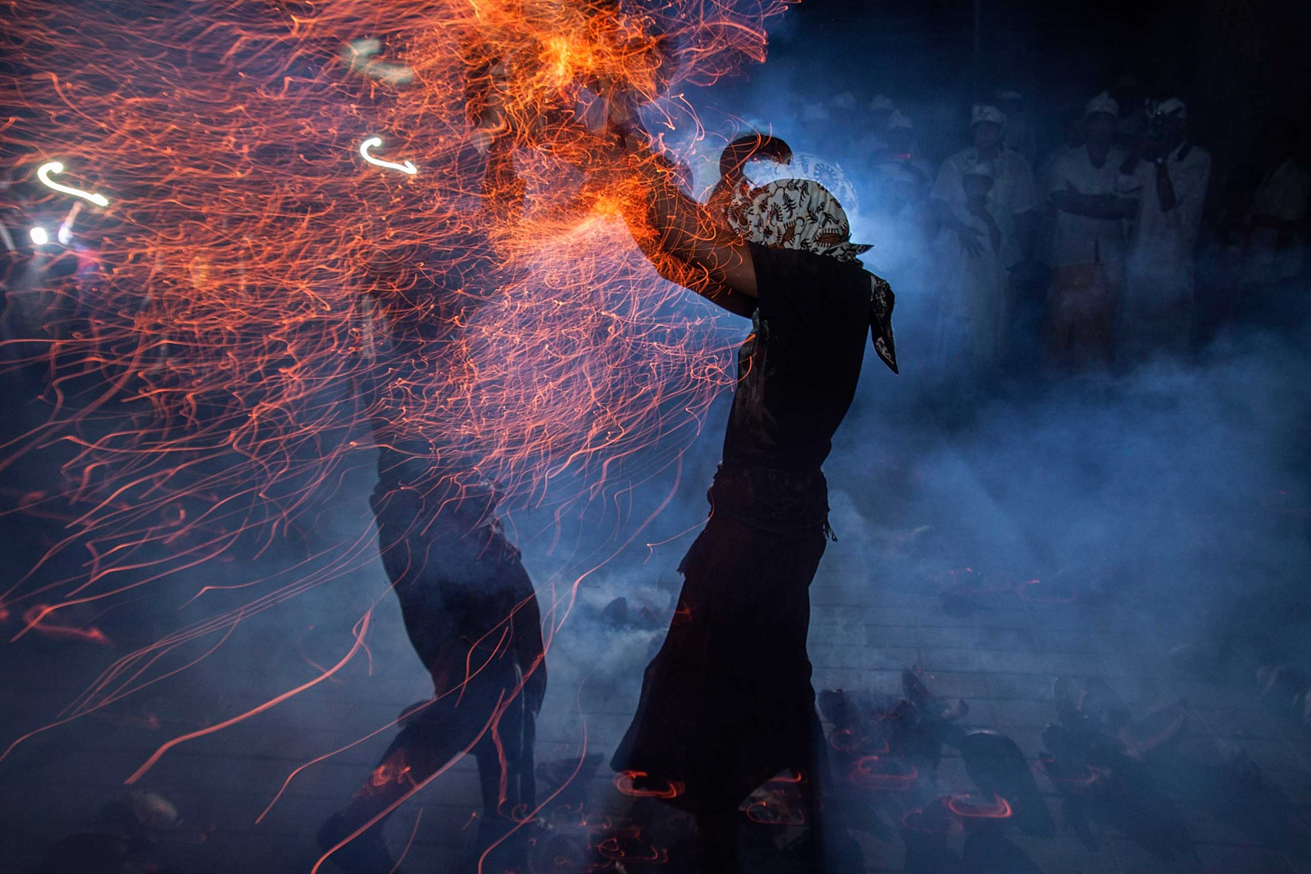KUTA, BALI - OCTOBER 19: Participants fight during fire war ceremony at Dalem Temple on October 19, 2013 in Tuban, Kuta, Indonesia. The annual ceremony, known locally as Siat Geni, is held to ward off bad luck and bring courage. (Photo by Putu Sayoga/Getty Images)