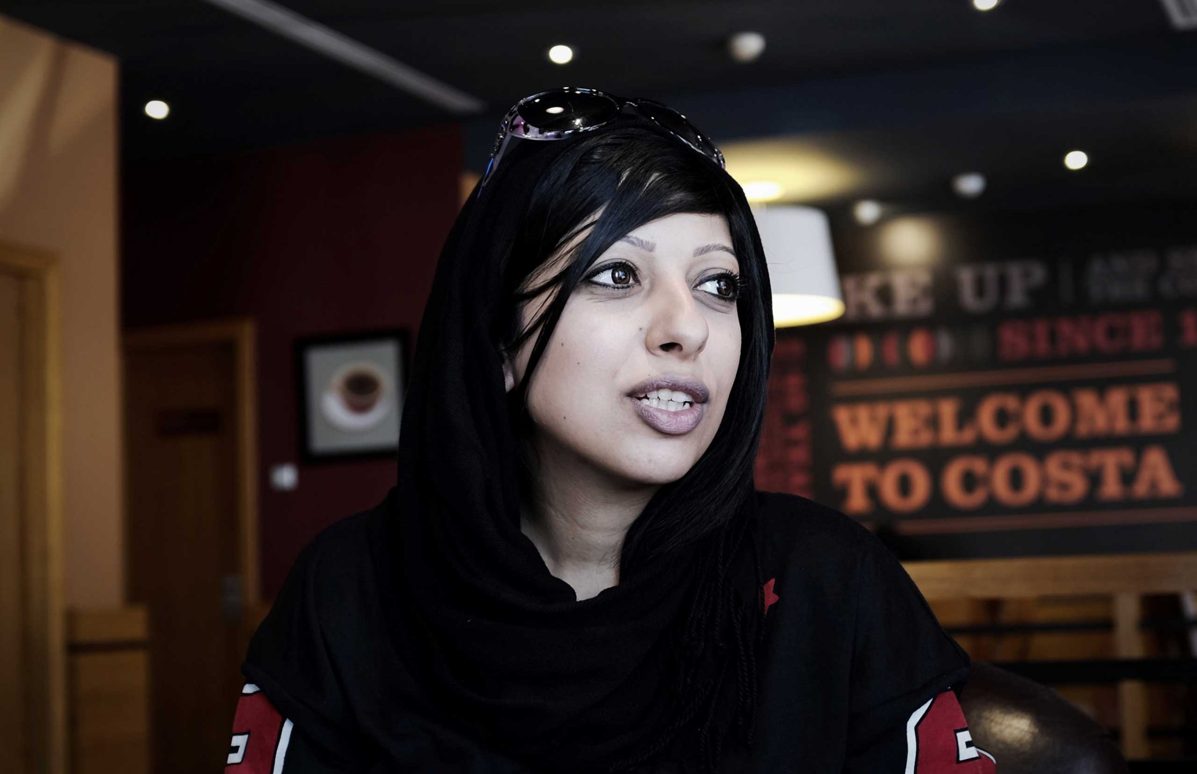 Bahraini human rights activist Zainab al-Khawaja, sister of jailed prominent rights activist Maryam al-Khawaja, sits at a cafe near the Bahrain court building after she was barred by authorities from attending the hearing, in the capital Manama on Sept. 6, 2014.