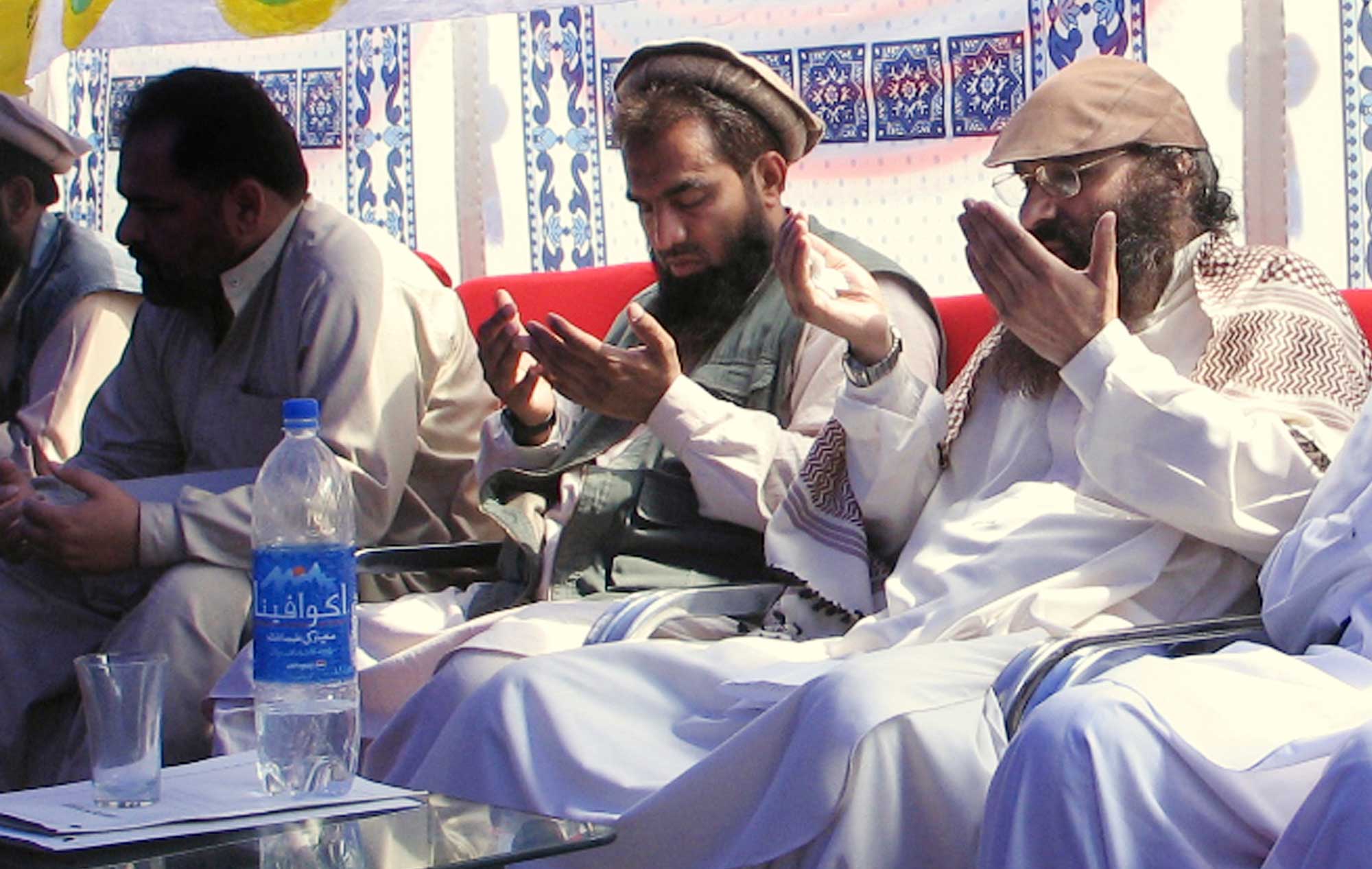 An alleged plotter of Mumbai attacks Pakistani Zaki-ur-Rehman Lakhvi, center, prays with Syed Salahuddin, right, chief of Hezbul Mujahideen or United Jehad Council, at a rally on June 28, 2008 in Muzaffarabad, capital of Pakistani Kashmir. (Roshan Mughal—AP)