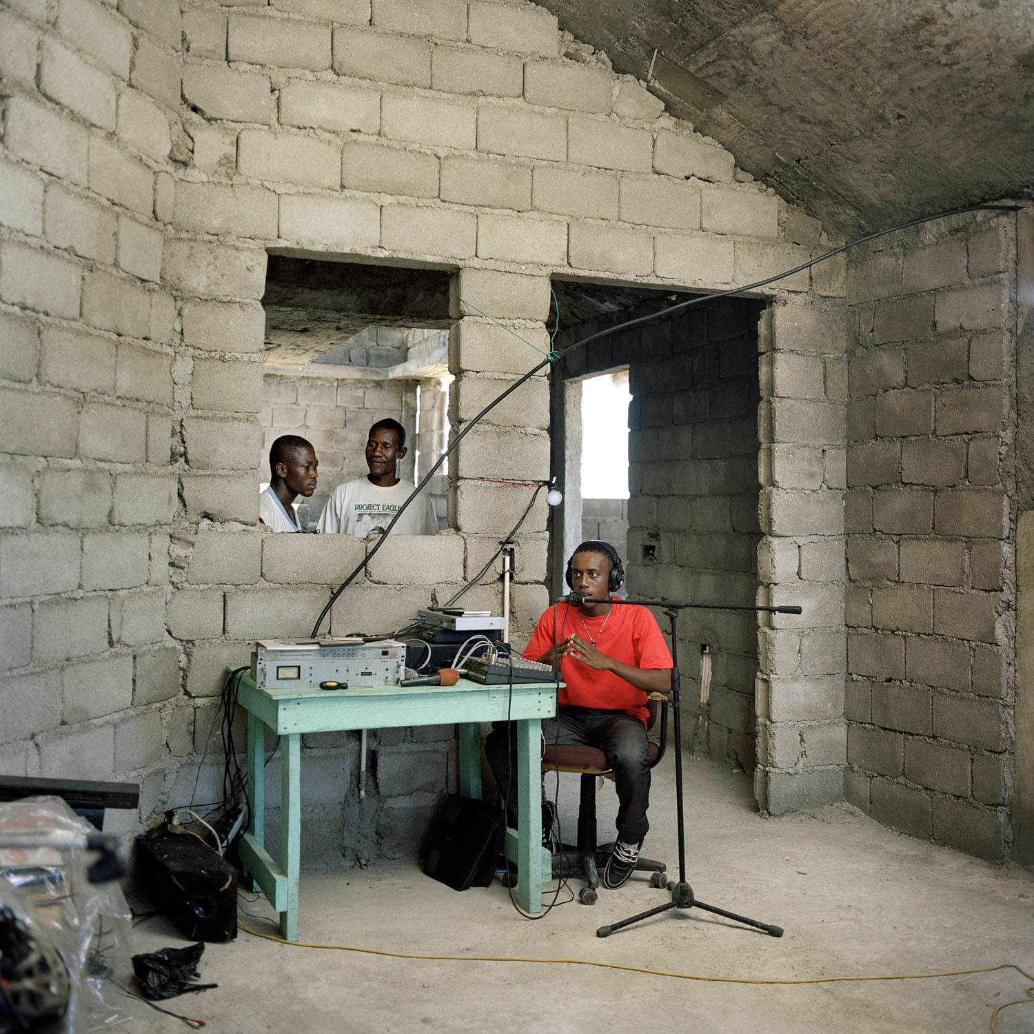 Radio Paradis 92.3FM. William is spinning from a building still under construction a few meters from the sea in the village of Tiburon, while his friends have come to check on him. The equipment for the radio has been paid by a ÒDiasporaÓ a Haitian living in the US. The radio is powered by solar panels and broadcasts ten hours a day. Haiti.Paolo WoodsÑINSTITUTE