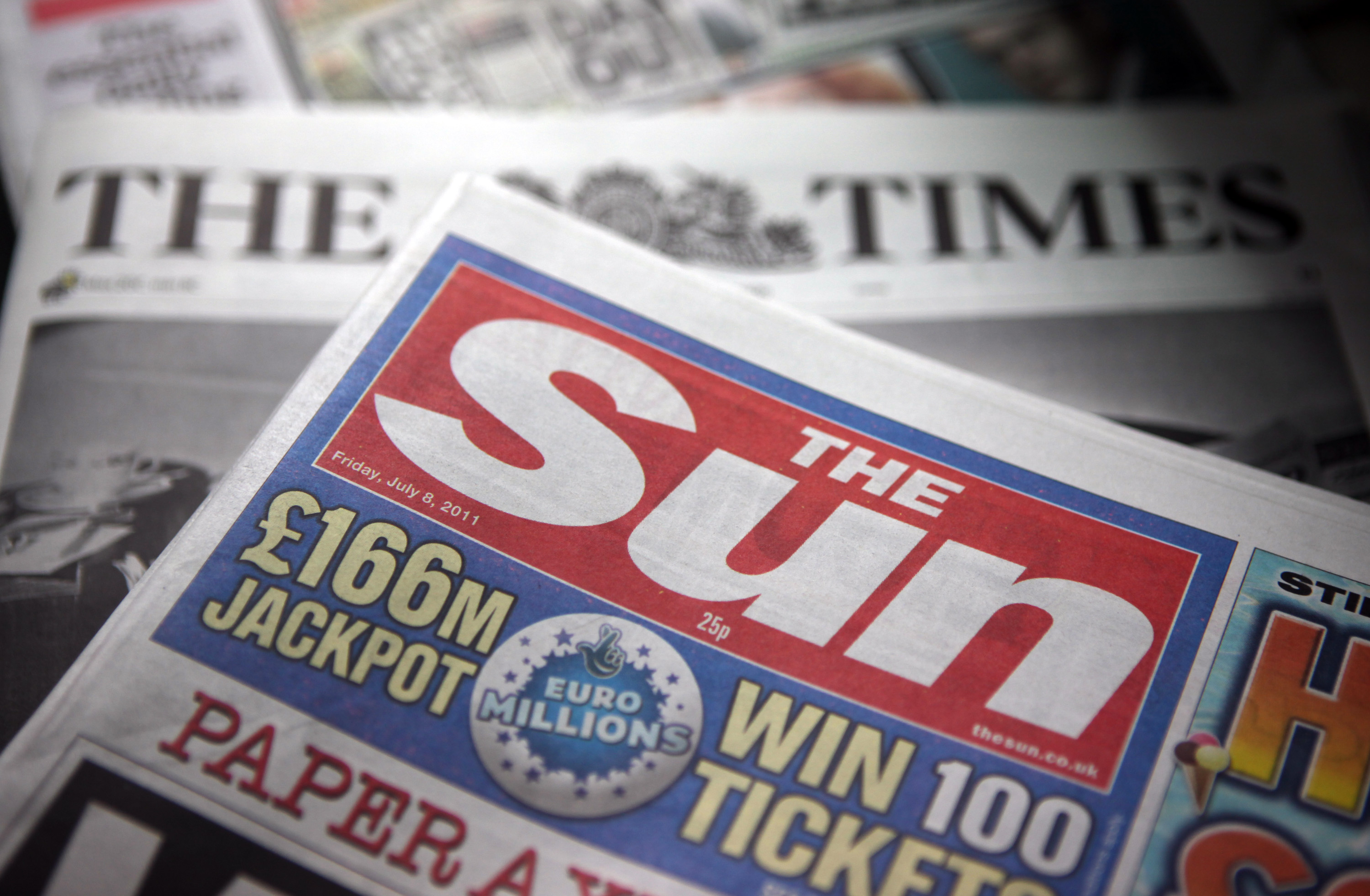 A copy of the <i>Sun</i> and the <i>Times</i> newspapers, published by News International are seen on display at a news agent in London on  July 8, 2011 (Bloomberg/Getty Images)