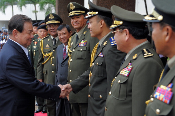Thai Defense Minister General Yuthasak Sasiprapa, left, shakes hands with Cambodia's internal-security chief Sao Sokha, right, upon his arrival at the Ministry of Defense in Phnom Penh on Sept. 23, 2011 (Tang Chhin Sothy—AFP/Getty Images)