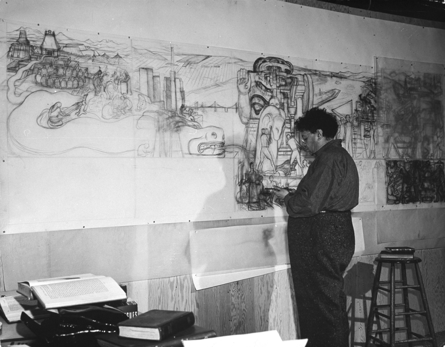 Diego Rivera working on pencil sketches for huge mural depicting Pan-American unity, Palace of Fine Arts, San Francisco, 1941.