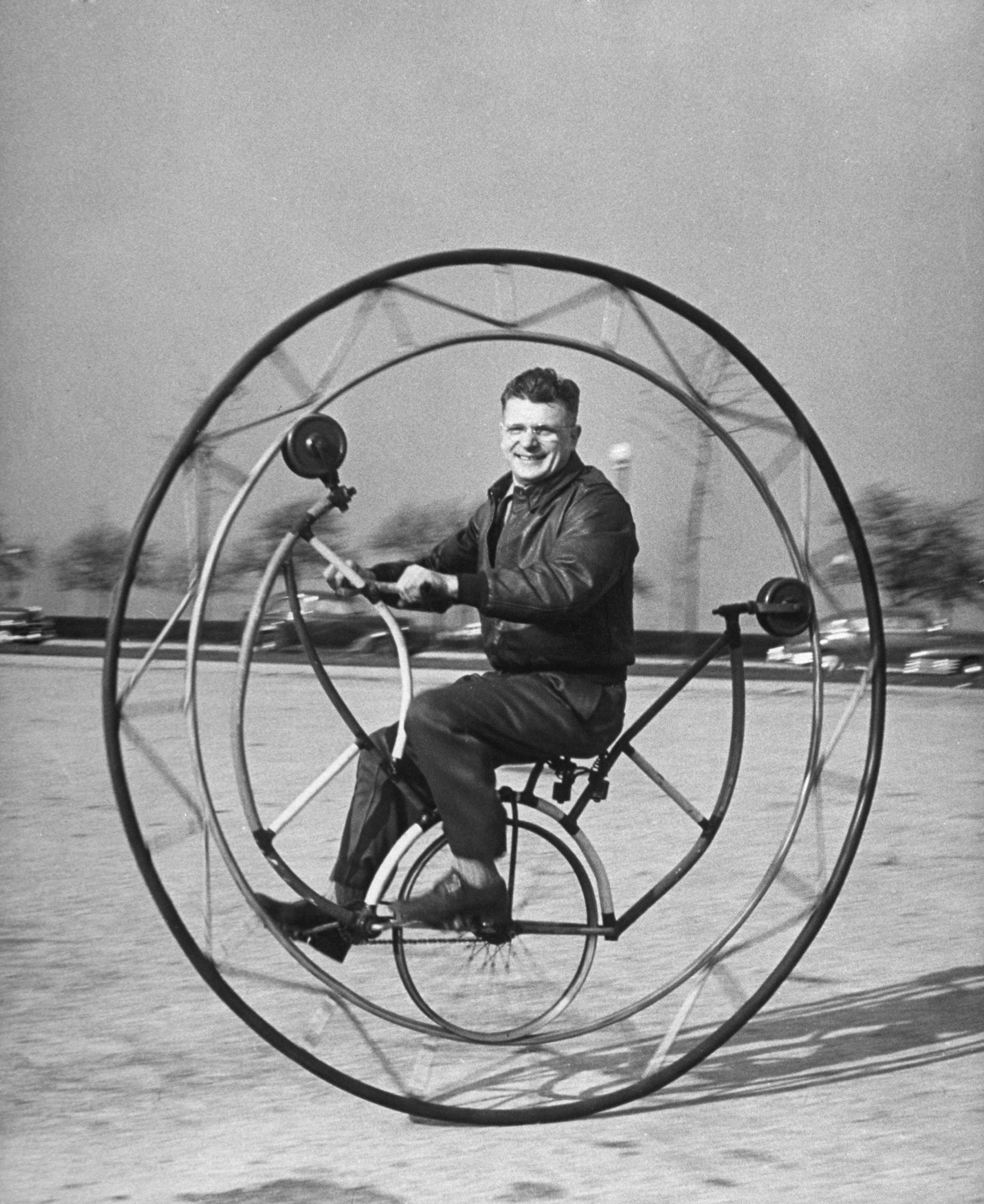 Uno-wheel bicycle, if braked suddenly, can send its rider round and round inside the big main wheel, designed by member of the Nat'l Bicycle Dealers' Assoc.