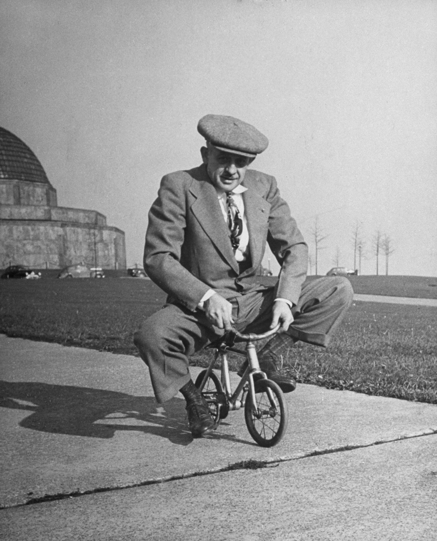 Chicago bicycle dealer Andy Koslow rides a tiny bike built by a former vaudevillian. "This helps limber up his left leg," LIFE wrote, "which, as a former motorcycle racer, he broke seven times."