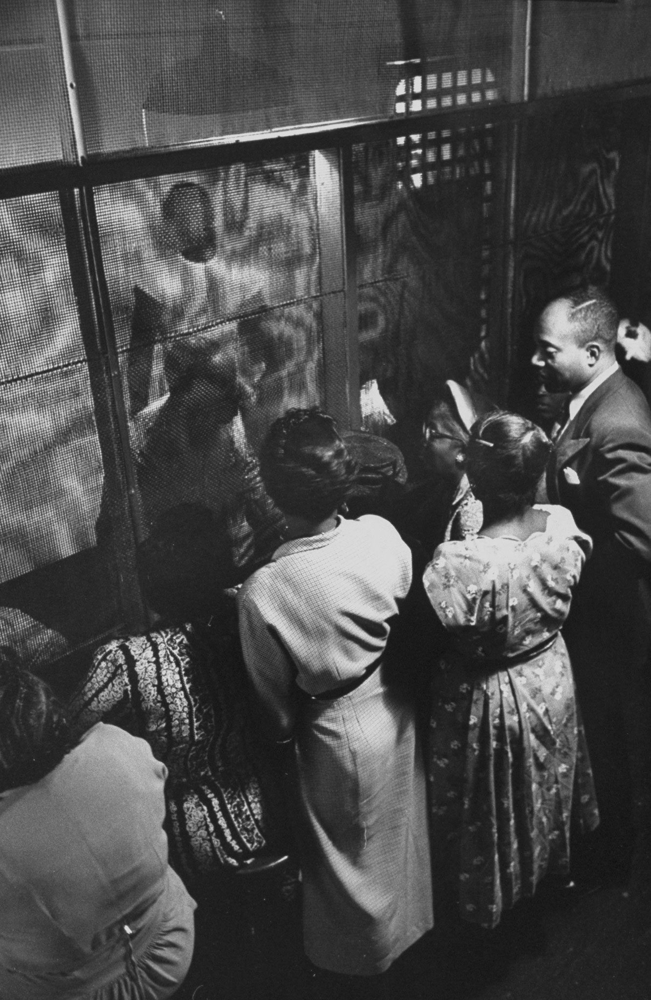 Prisoners talk through heavy screens to friends and relatives, Tennessee State Penitentiary, 1953.