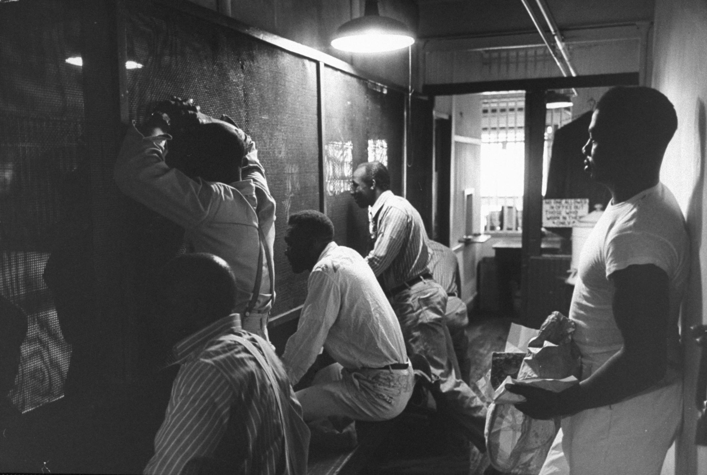 Prisoners talk through heavy screens to friends and relatives, Tennessee State Penitentiary, 1953.