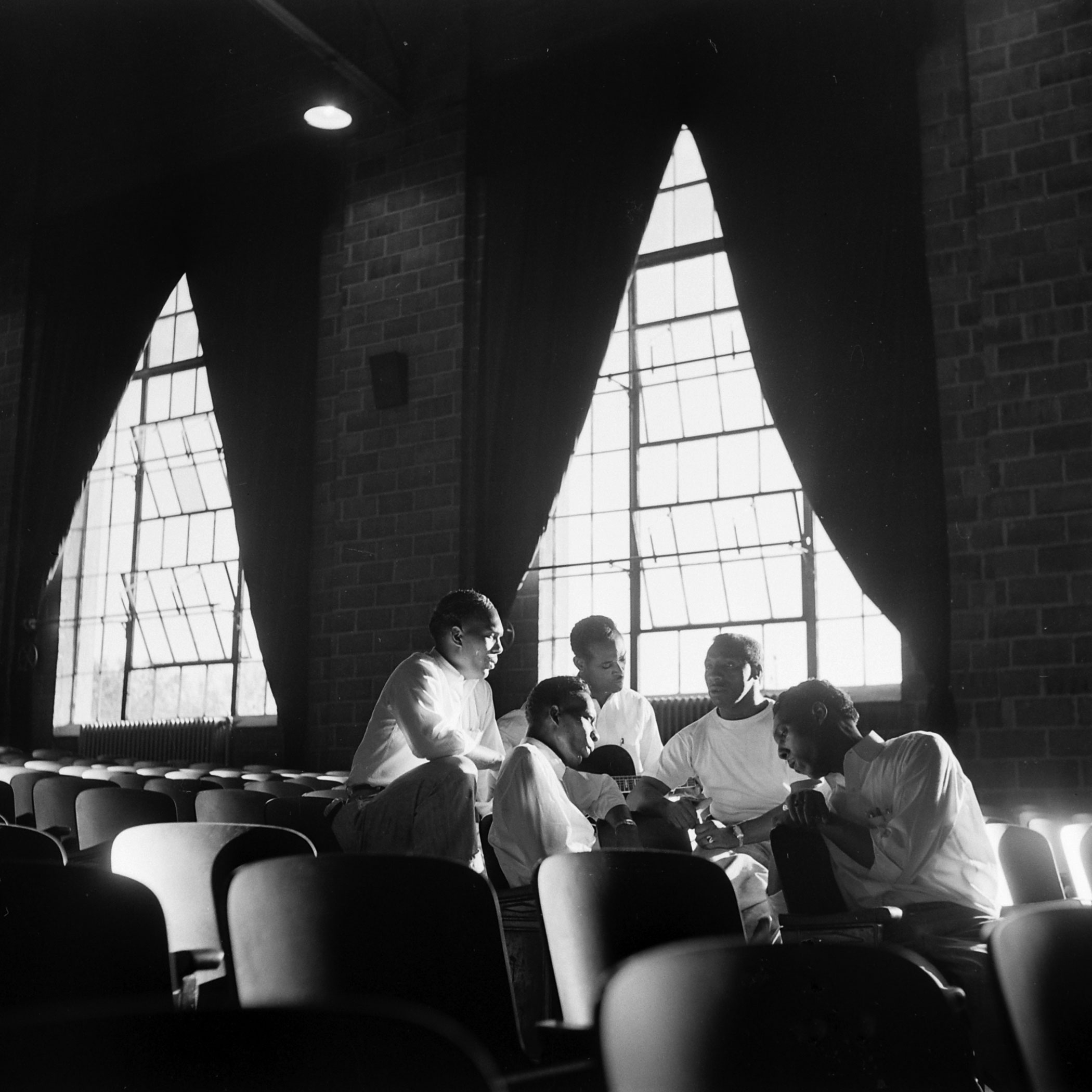 Members of the incarcerated musical group the Prisonaires rehearse in the prison auditorium, Tennessee, 1953.