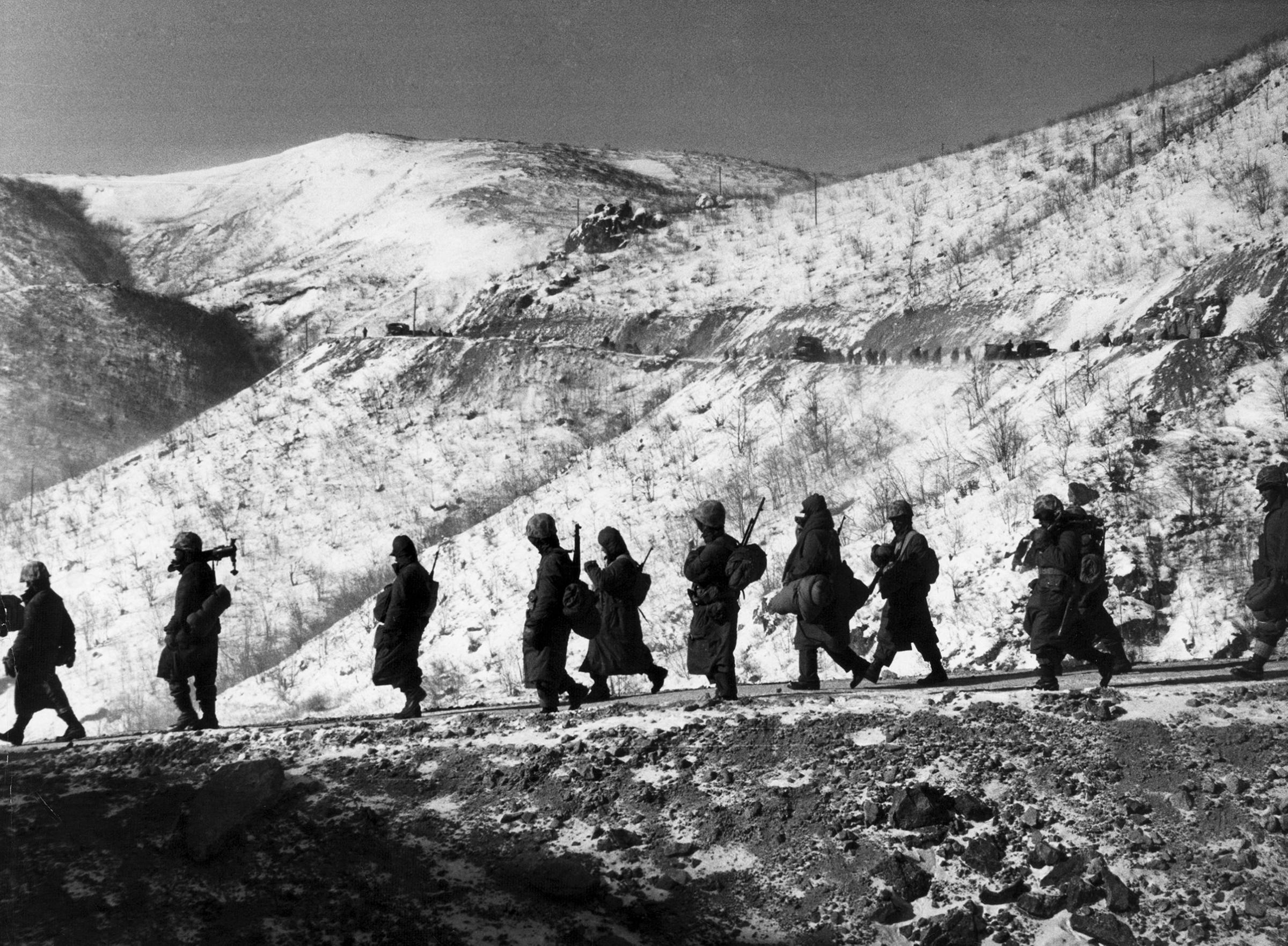 American Marines march down a canyon road dubbed "Nightmare Alley" during their retreat from Chosin Reservoir, Korea, 1950.