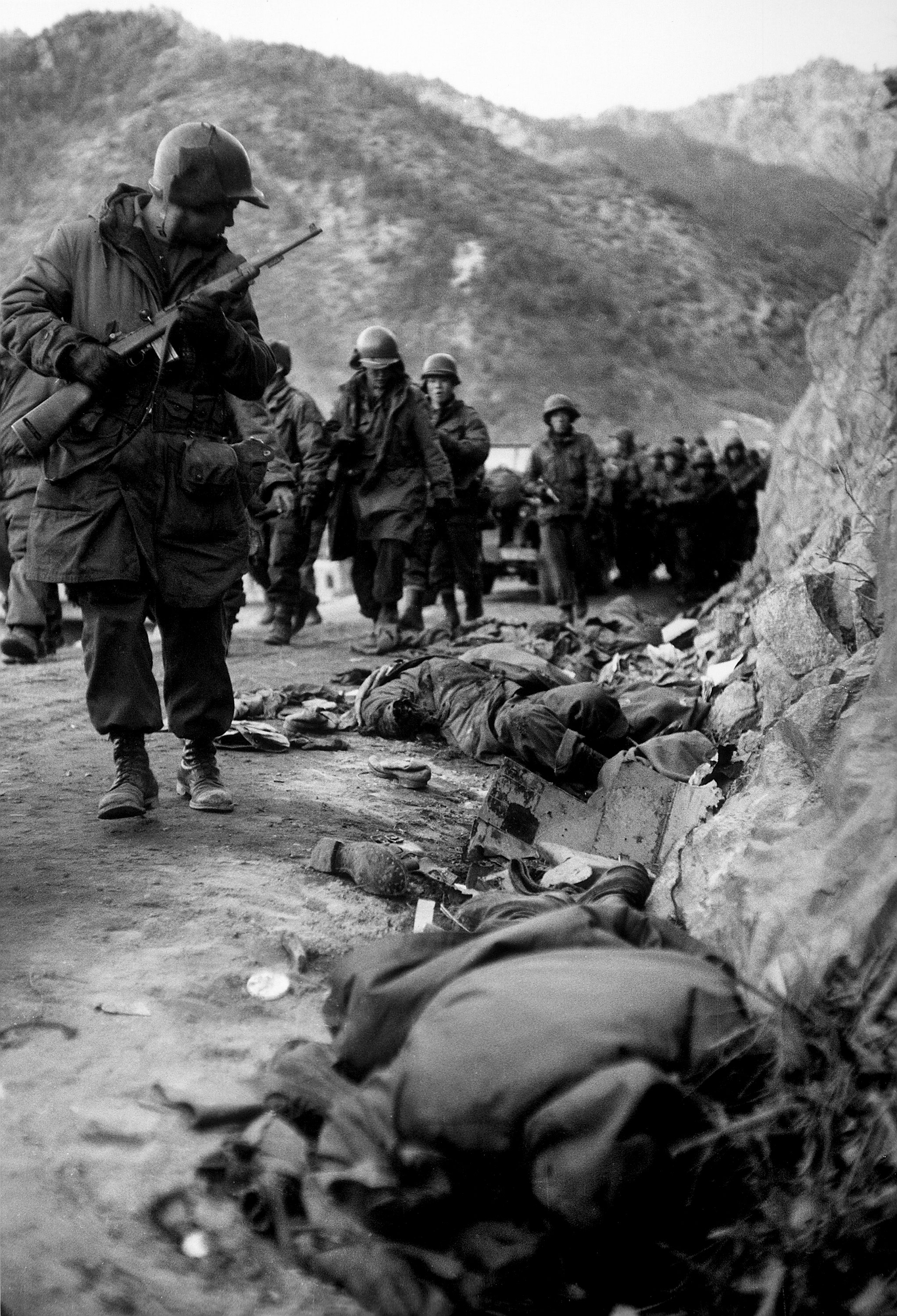 American Marines pass bodies of fallen comrades during the retreat from the Chosin Reservoir, December 1950.