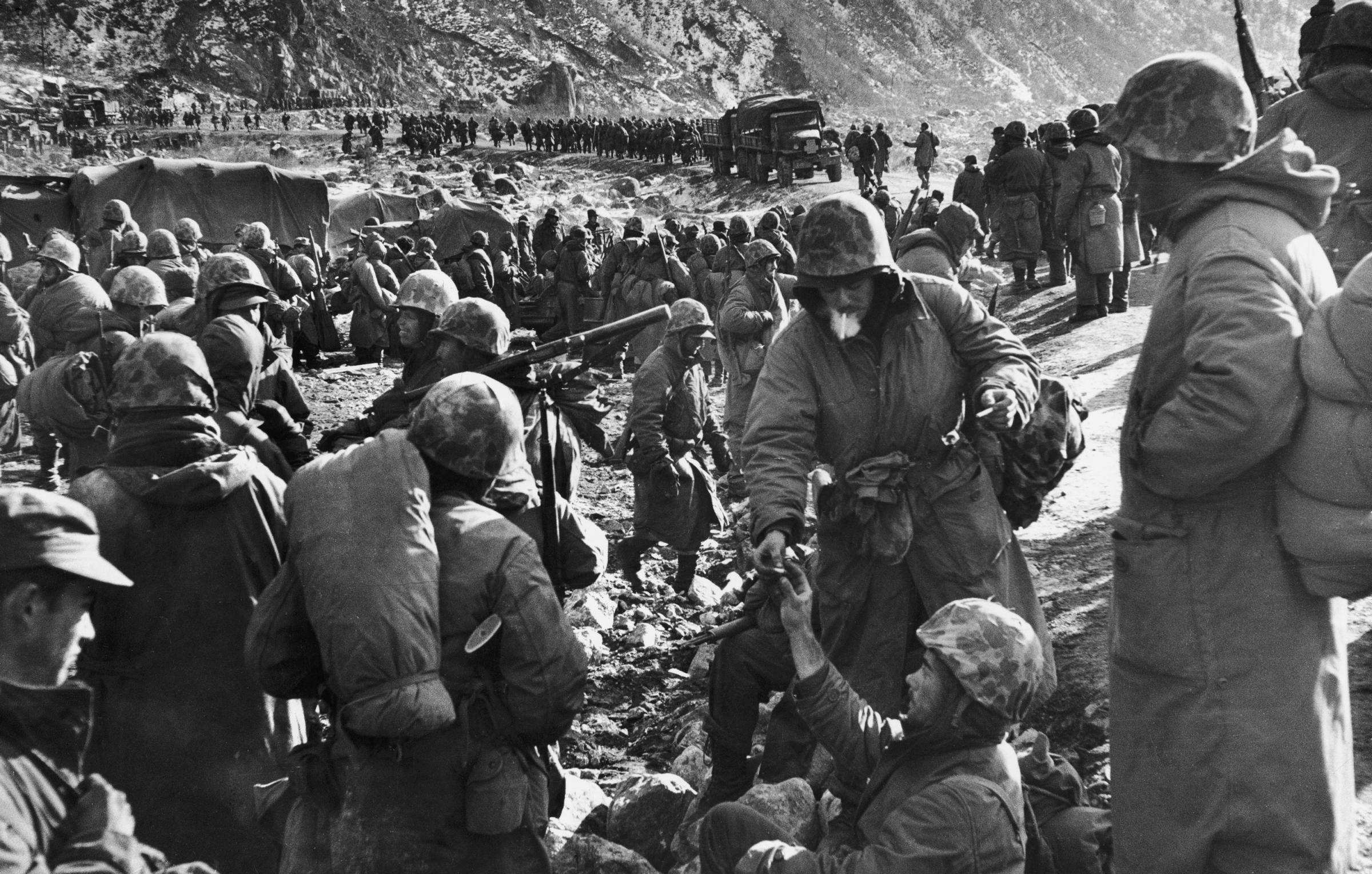 Marines rest after making it through the canyon road known as Nightmare Alley during the retreat from the Chosin Reservoir, December 1950.