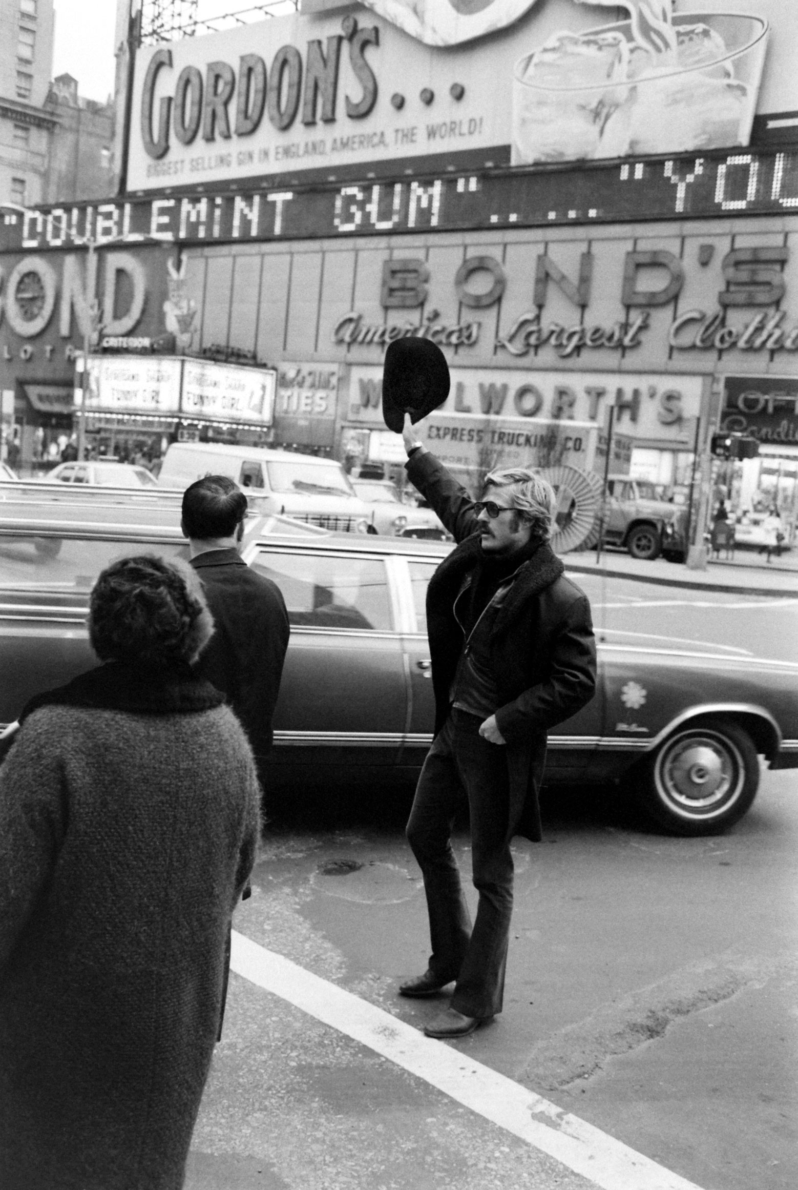 Robert Redford hails a cab in Times Square