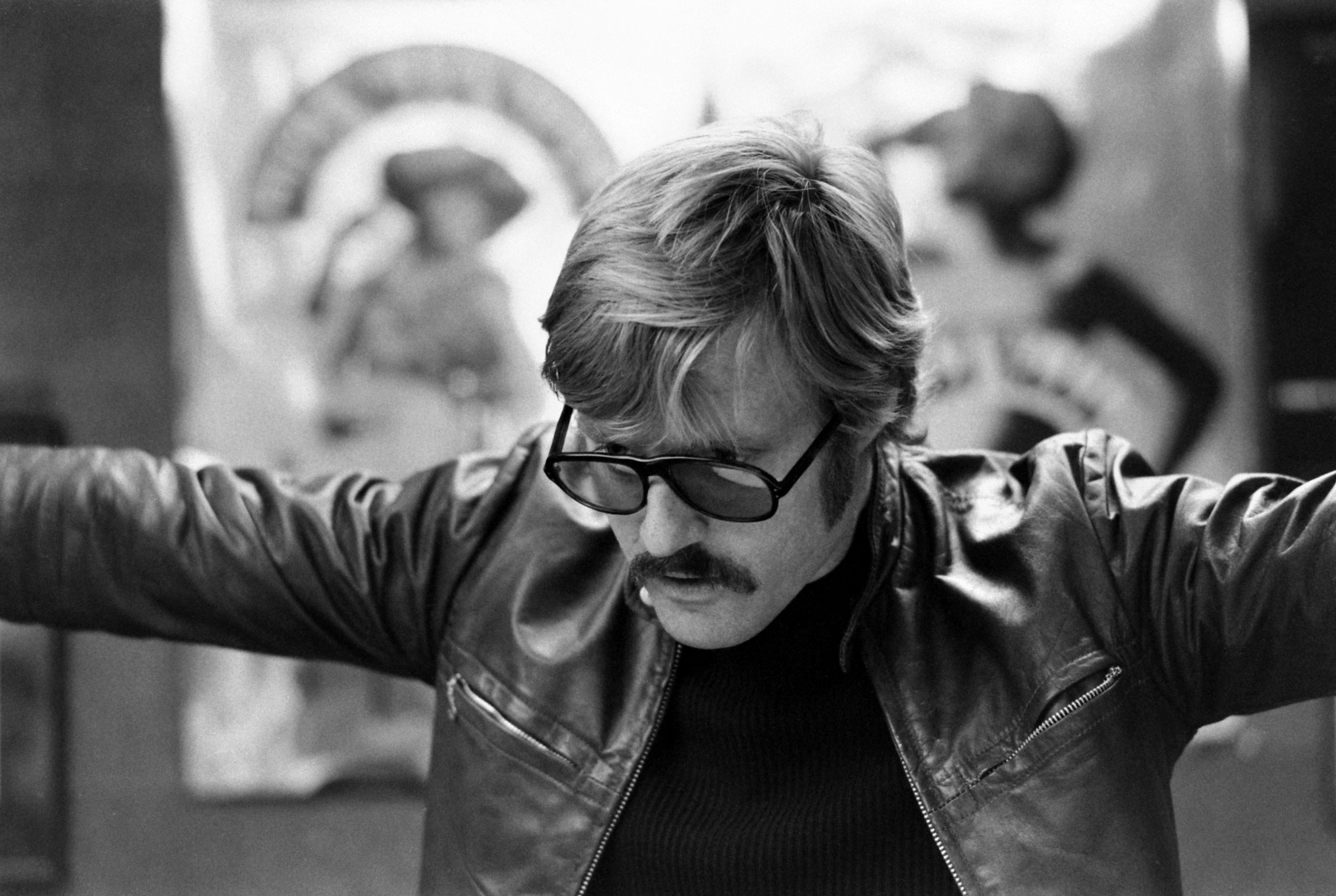 Robert Redford looks over promotional photos and ads for "Downhill Racer"