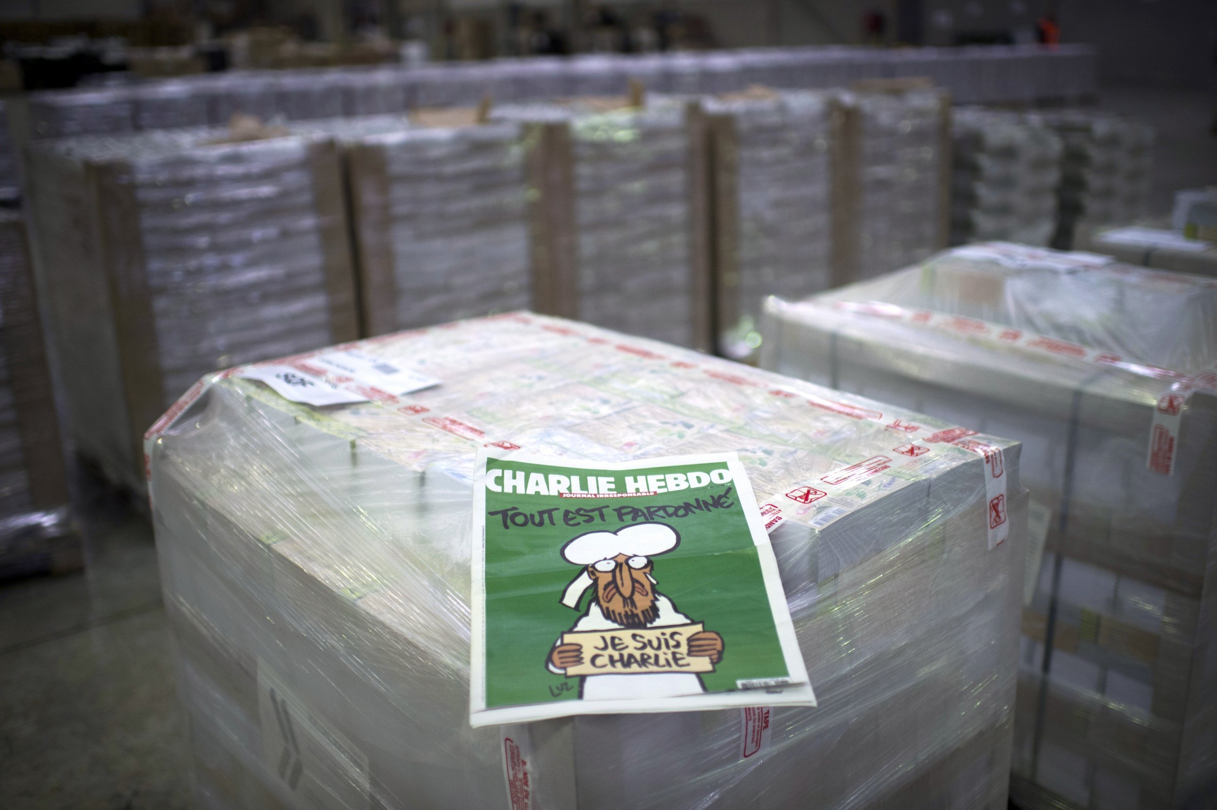 The weekly newspaper Charlie Hebdo, on January 13, 2015 in Villabe, south of Paris, a week after two jihadist gunmen stormed the Paris offices of the satirical magazine, killing 12 people including some of the country's best-known cartoonists. Its cover features the prophet with a tear in his eye, holding a "Je Suis Charlie" sign under the headline "All is forgiven".