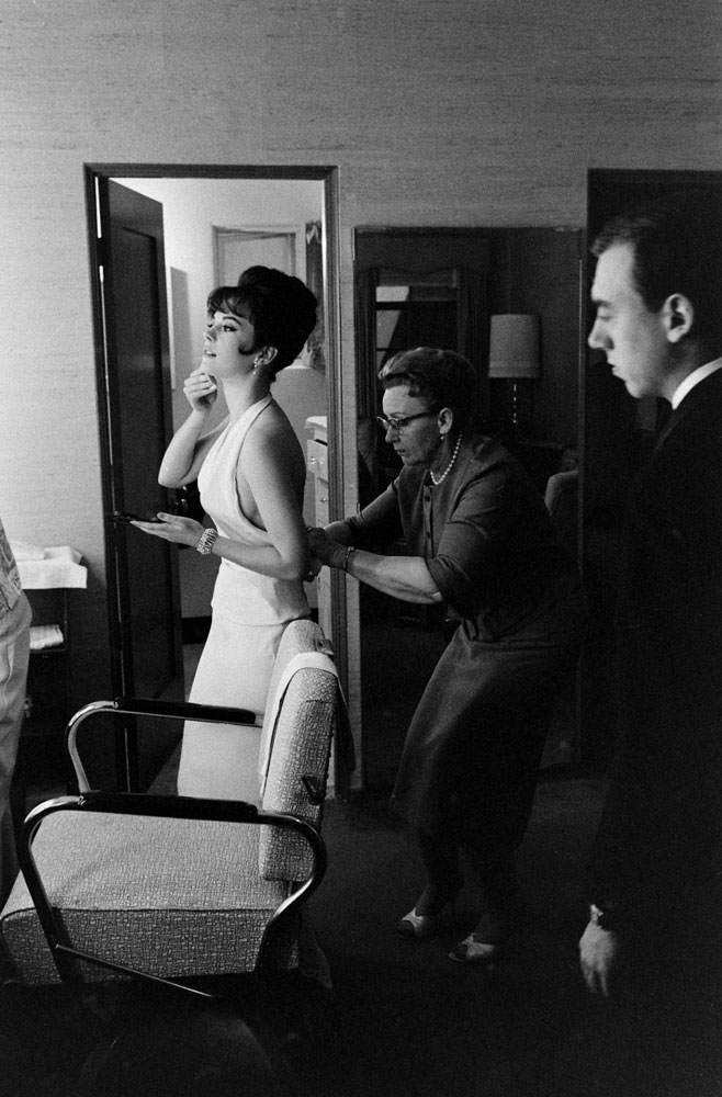 An assistant helps Natalie Wood into a showstopping, skin-baring number in April 1962.