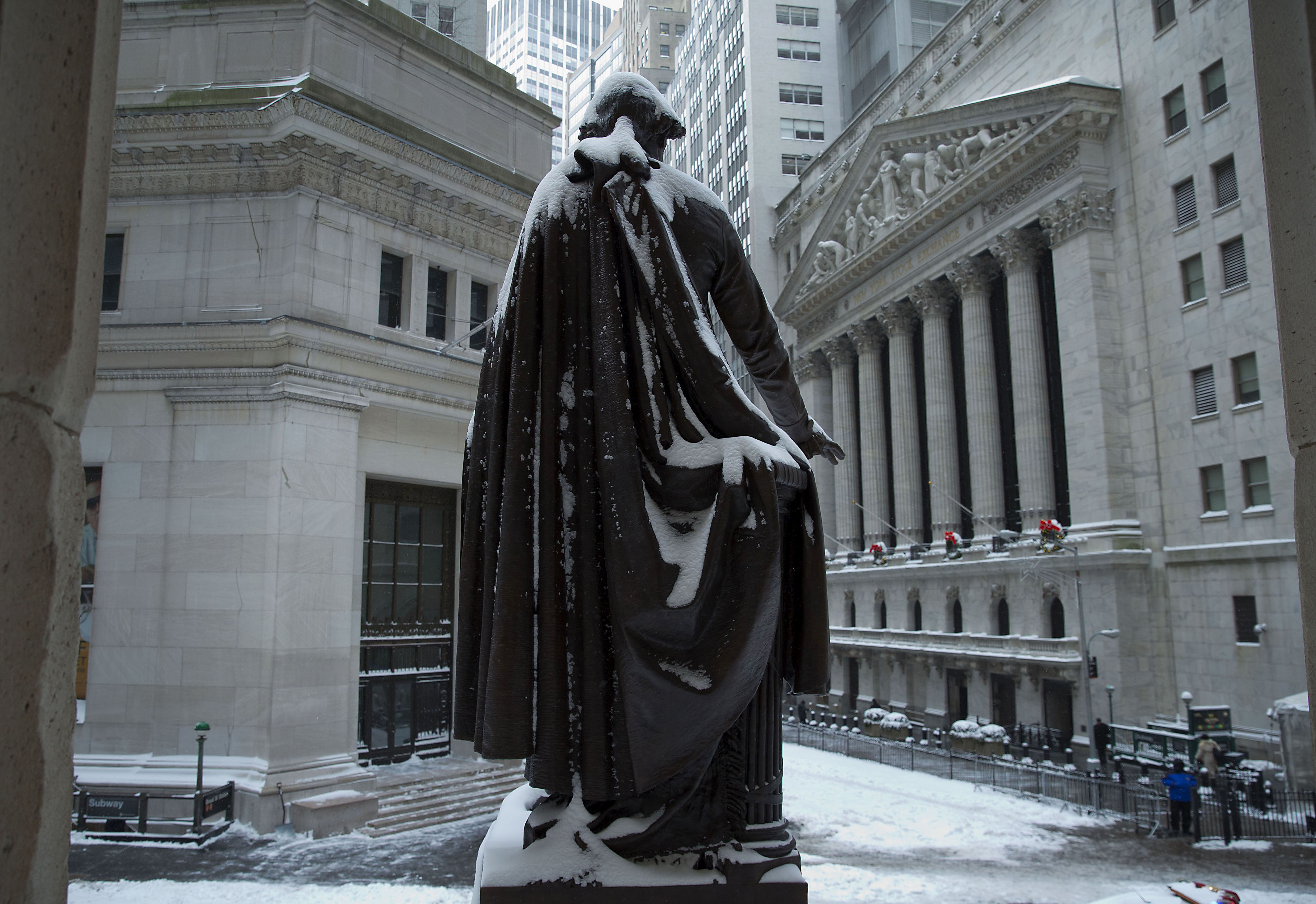 The George Washington statue stands covered in snow near the New York Stock Exchange (Jin Lee&mdash;Bloomberg via Getty Images)
