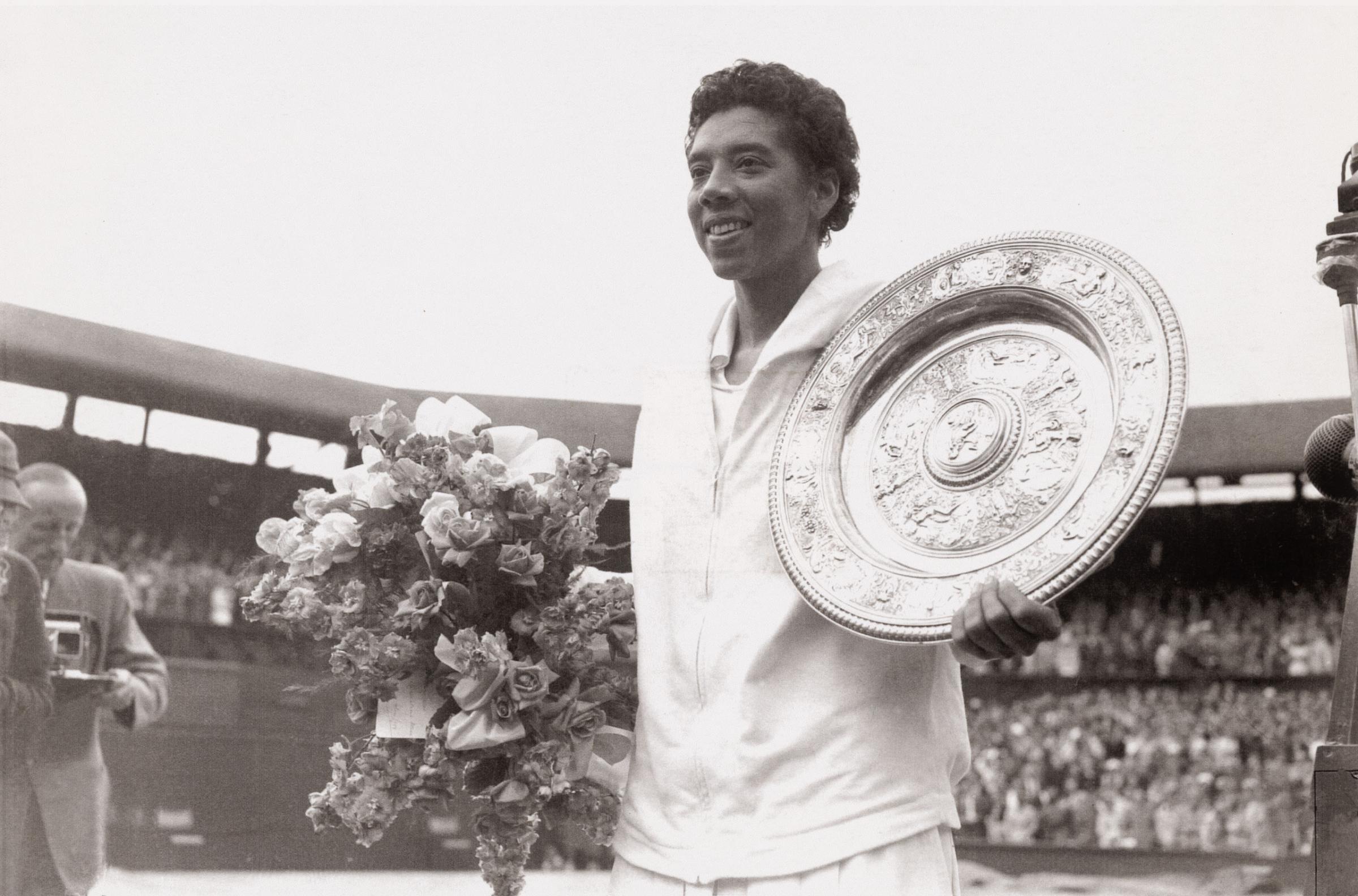 Althea Gibson holding a Wimbledon trophy plate, July 1957.