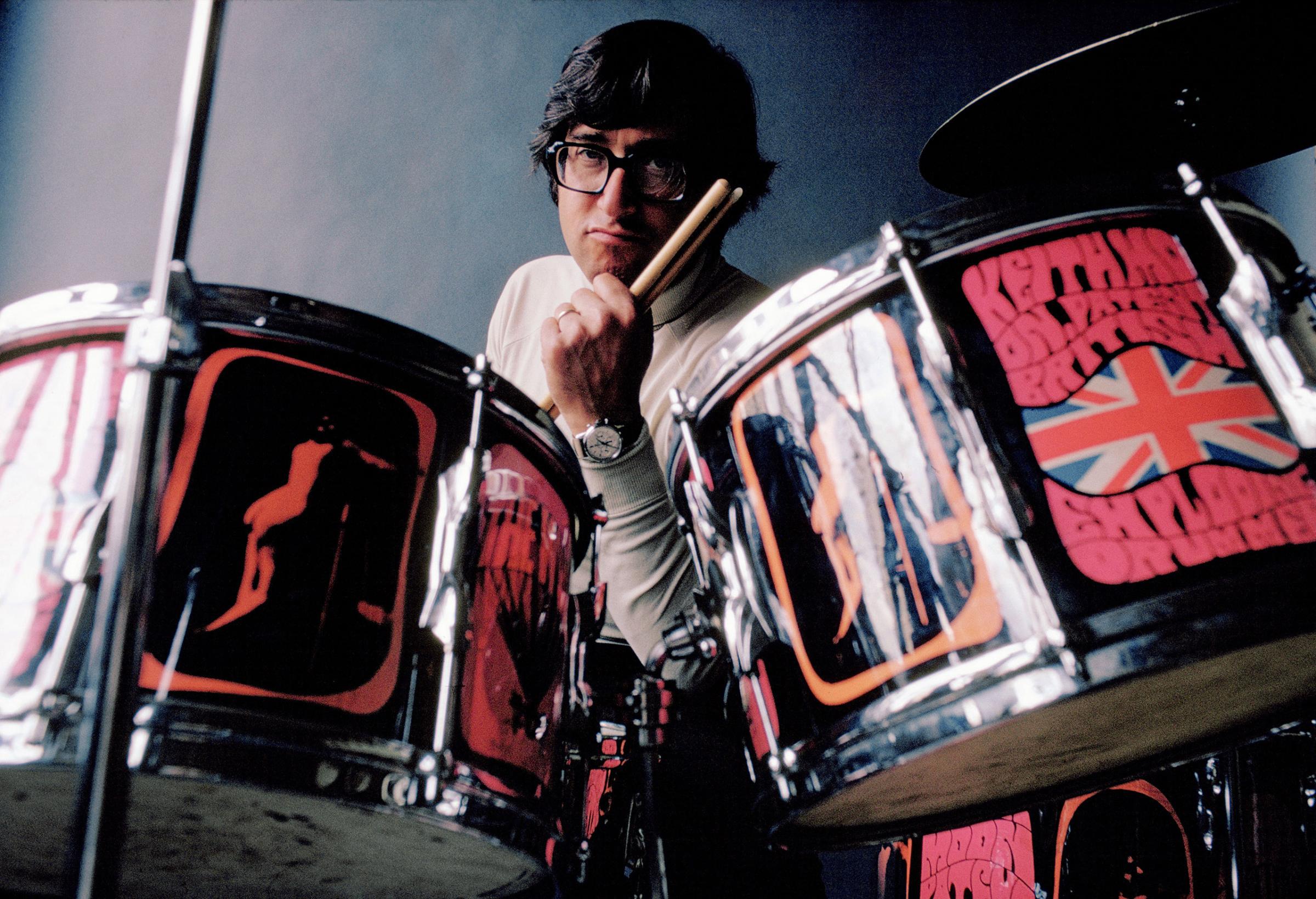 Photographer Art Kane at Keith Moon's drum set, 1968.