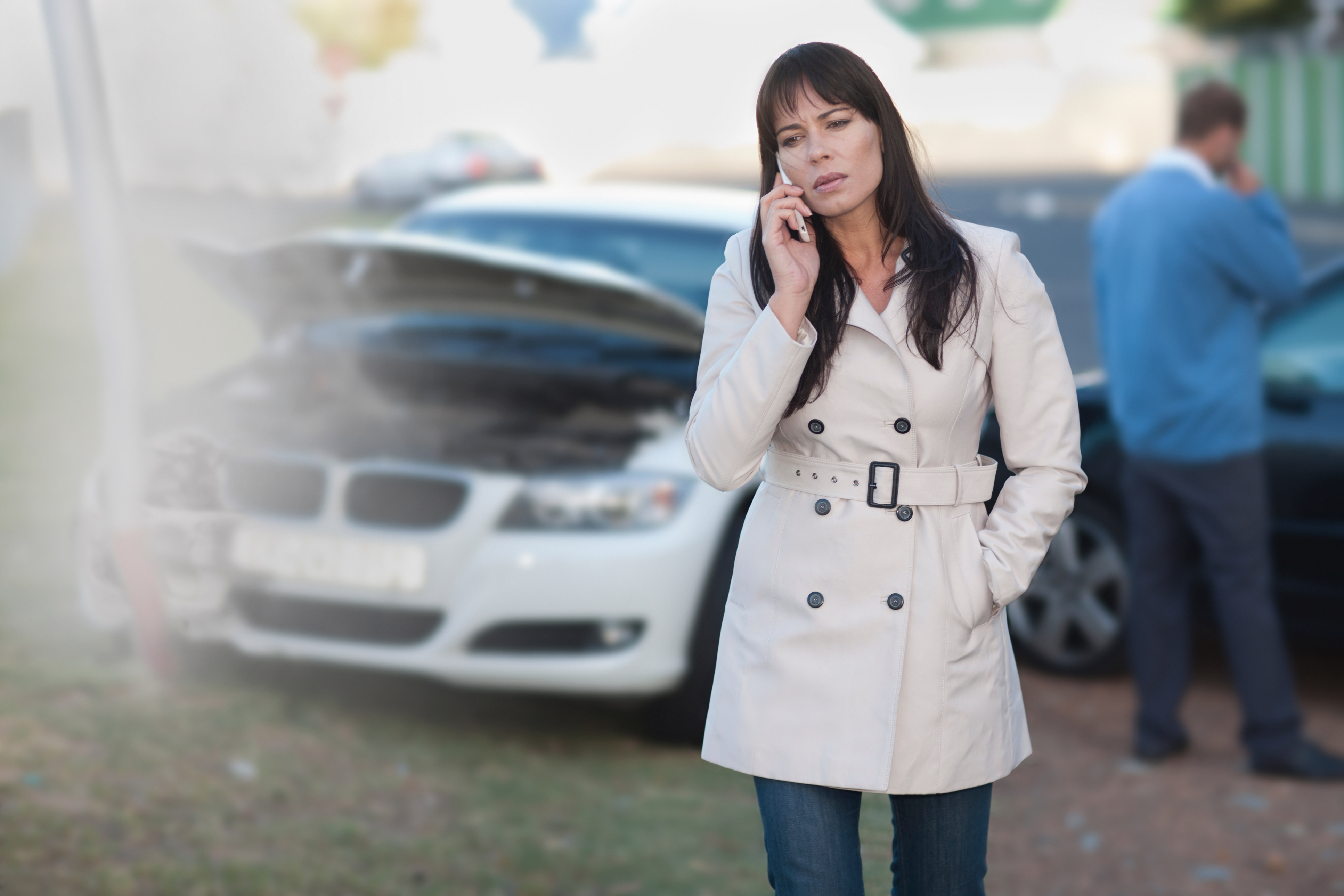 Woman on mobile phone after car accident (Zero Creatives&mdash;Getty Images/Image Source)