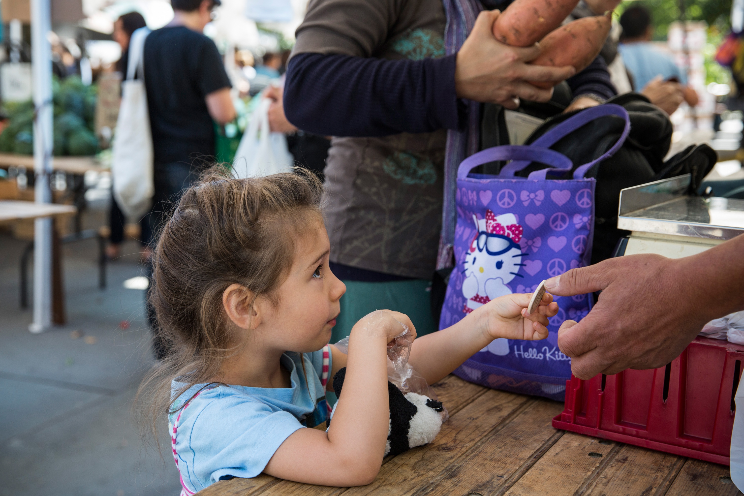 A girl pays for her mother's groceries using Electronic Benefits Transfer (EBT) tokens, more commonly known as Food Stamps, at the GrowNYC Greenmarket in Union Square on September 18, 2013 in New York City. (Andrew Burton—Getty Images)