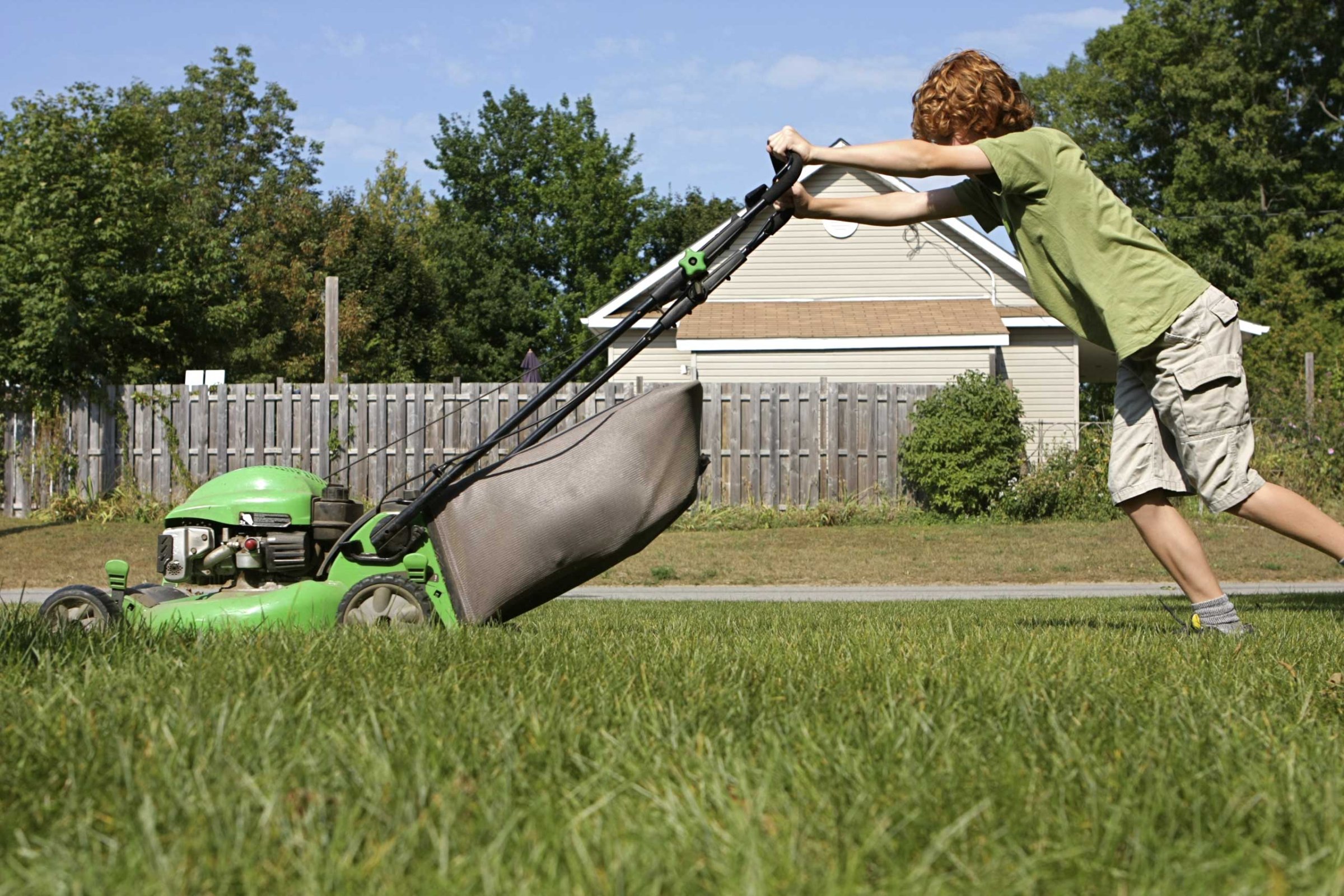teenager mowing lawn