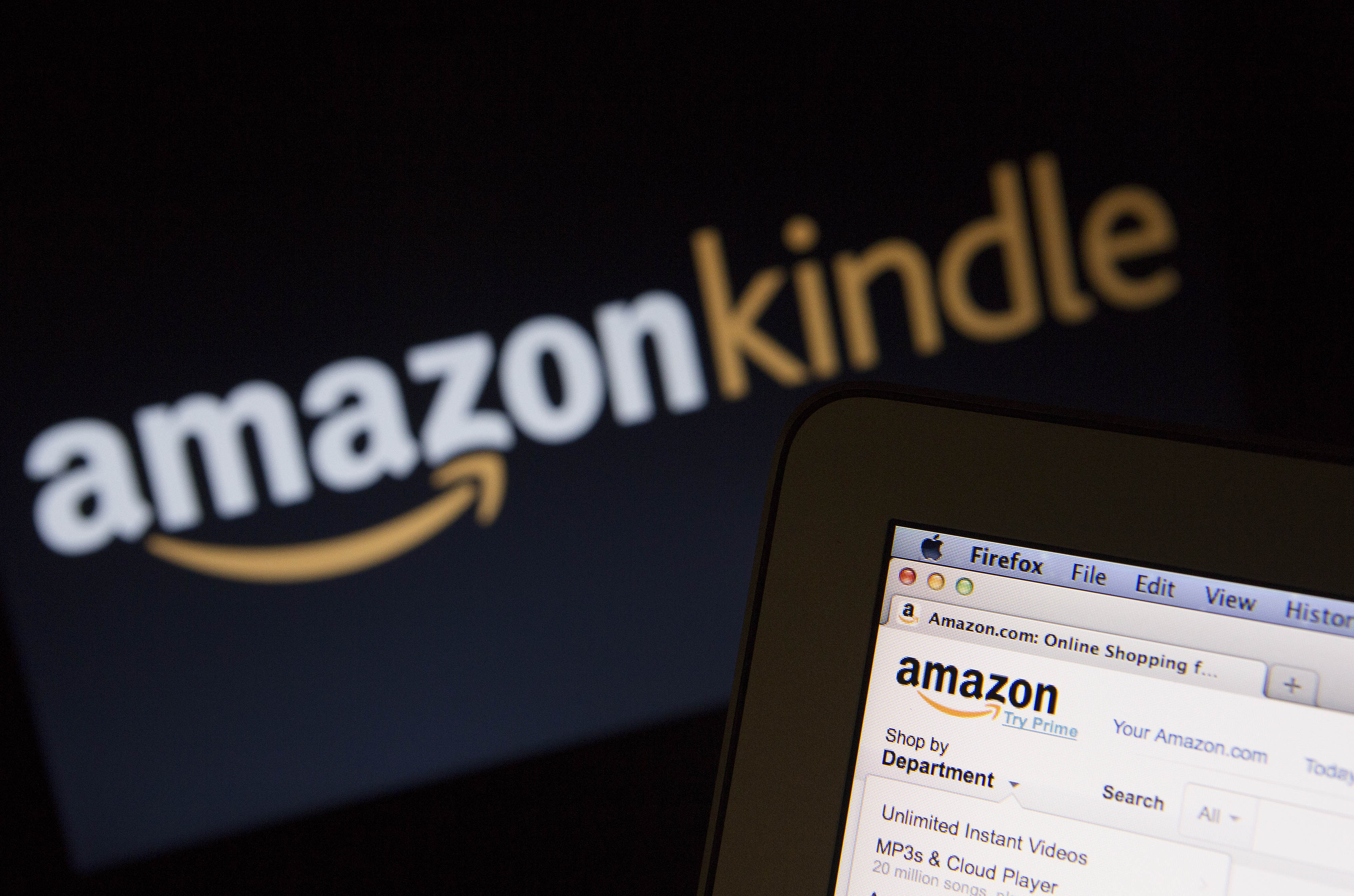 The Amazon.com Inc. homepage and Amazon Kindle logo are displayed on laptop computers in Washington, D.C., U.S., on Wednesday, Oct. 23, 2013. (Andrew Harrer—Bloomberg/Getty Images)