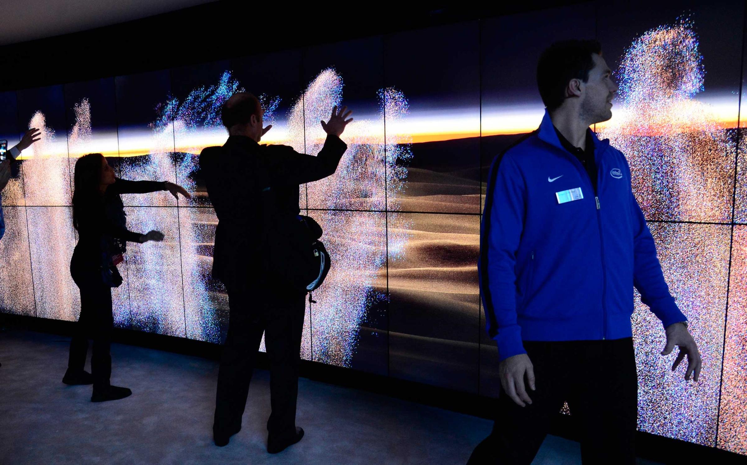 Attendees interact with wity screens that run on Intel's Realsense technology on Jan. 6, 2015.