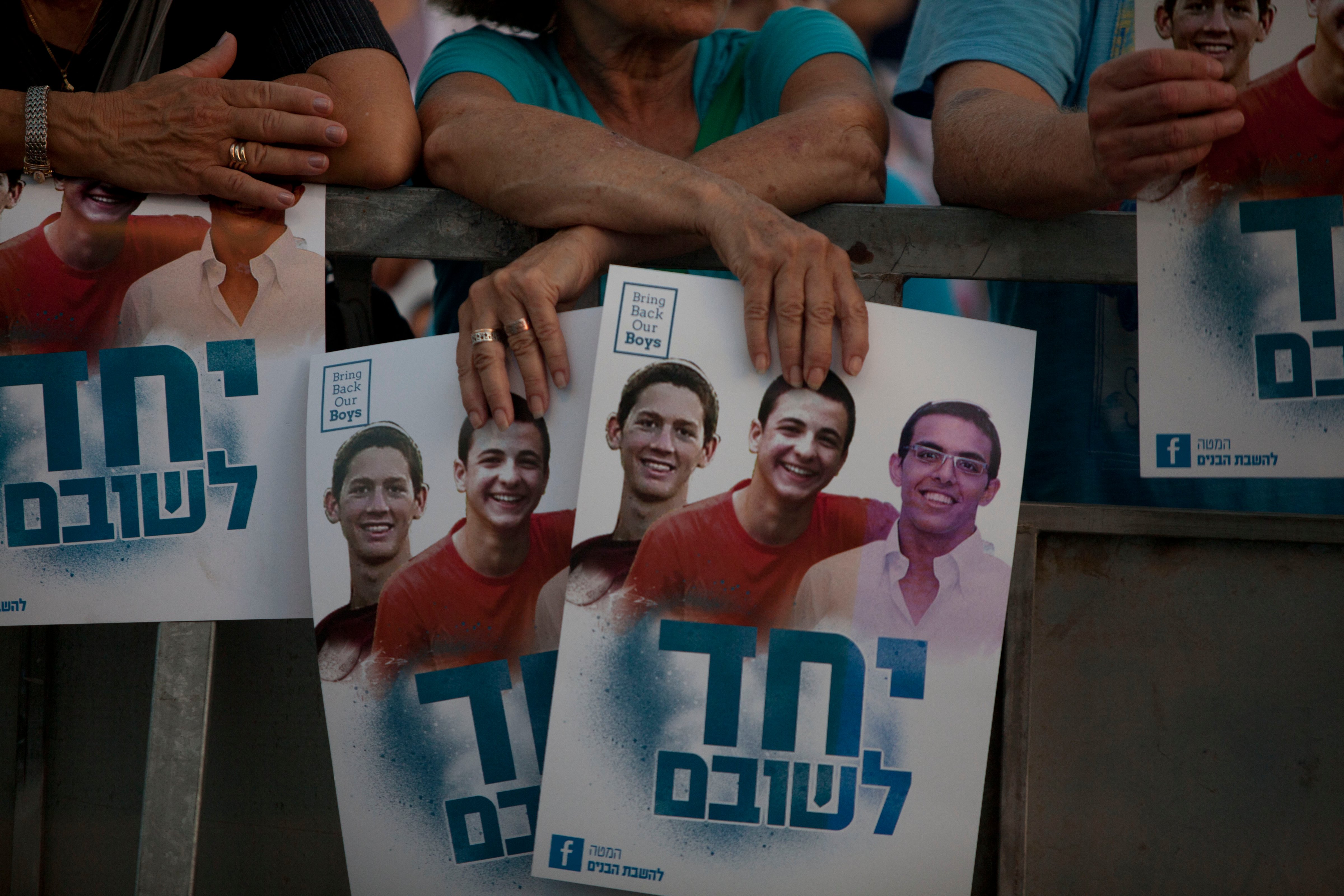 Israelis hold a poster showing the three missing Israeli teenagers, as they attend a rally under the slogan 'Bring Our Boys Home' on June 29, 2014 in Tel Aviv, Israel. (Lior Mizrahi—Getty Images)