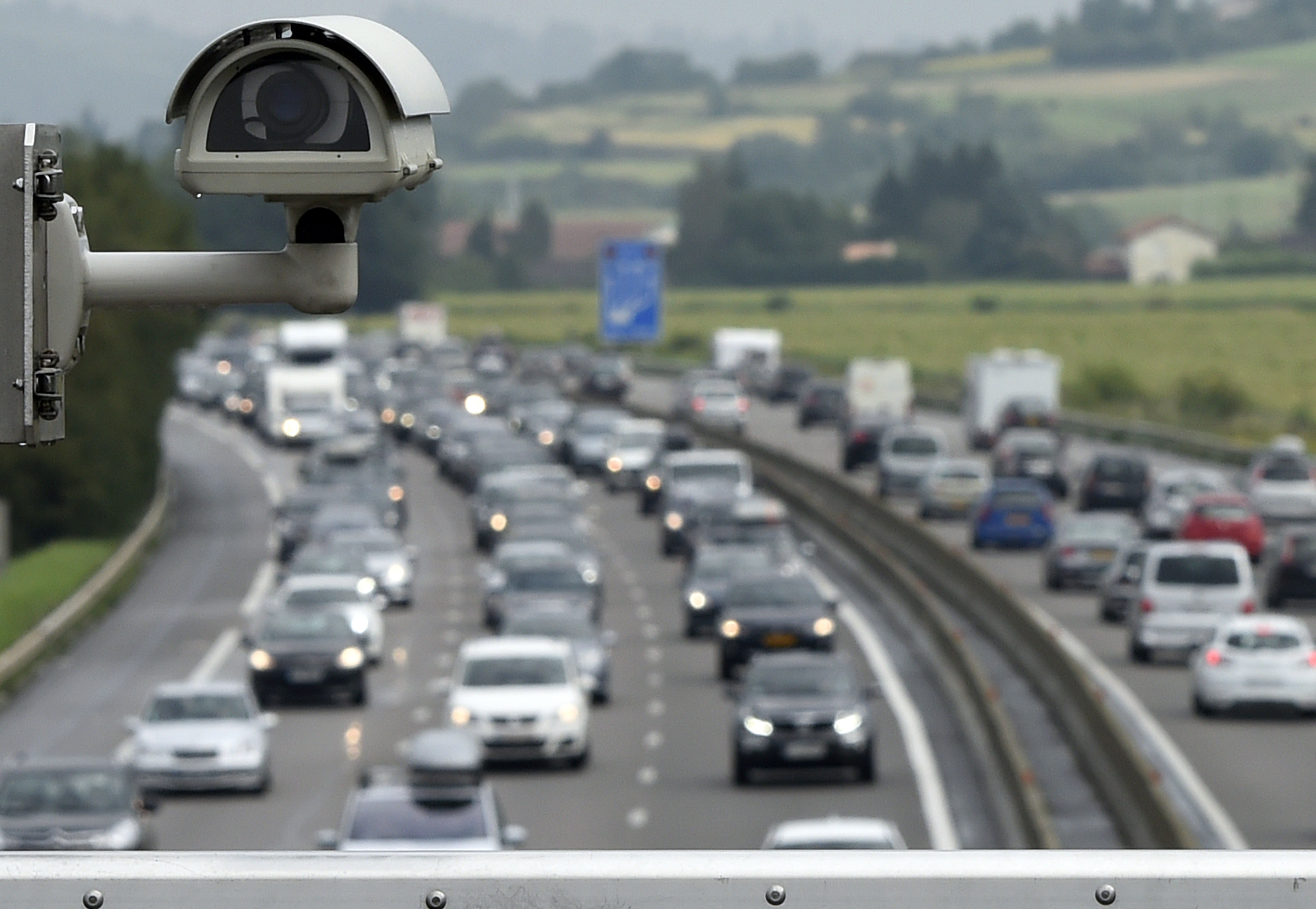 Motorists drive in traffic on the A7 motorway under a bridge where a security camera is set on August 2, 2014 at the toll station of Vienne, southeastern France. (Philippe Desmazes—AFP/Getty Images)