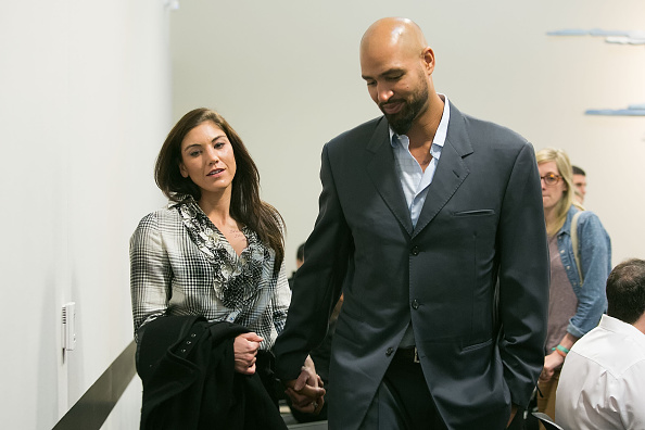Hope Solo and husband Jerramy Stevens exit the court room at Kirkland Municipal Court in Washington on Nov. 4, 2014 (Suzi Pratt—Getty Images)