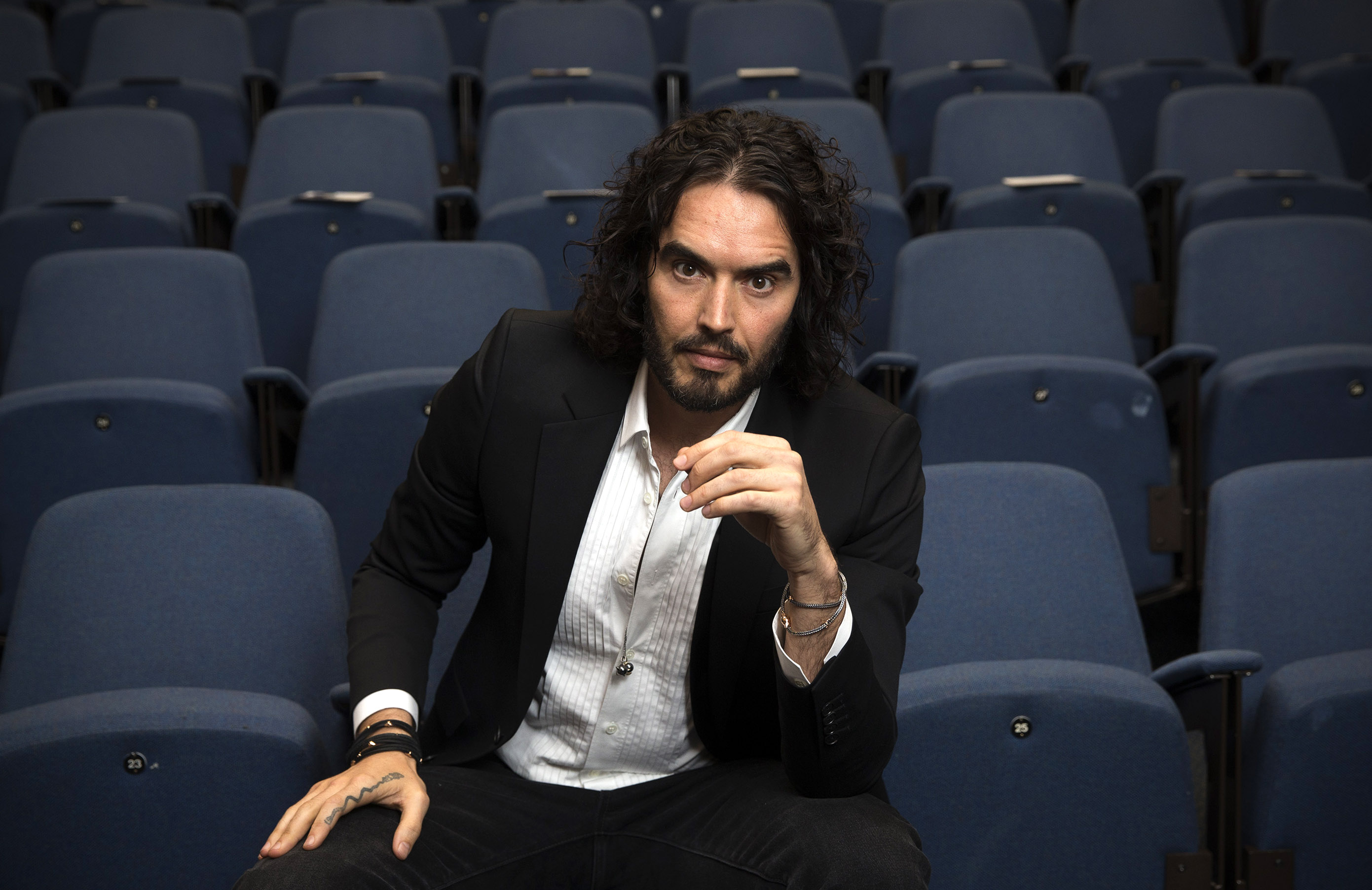 Russell Brand poses for photographs as he arrives to deliver The Reading Agency Lecture at The Institute of Education on Nov. 25, 2014 in London, England.
