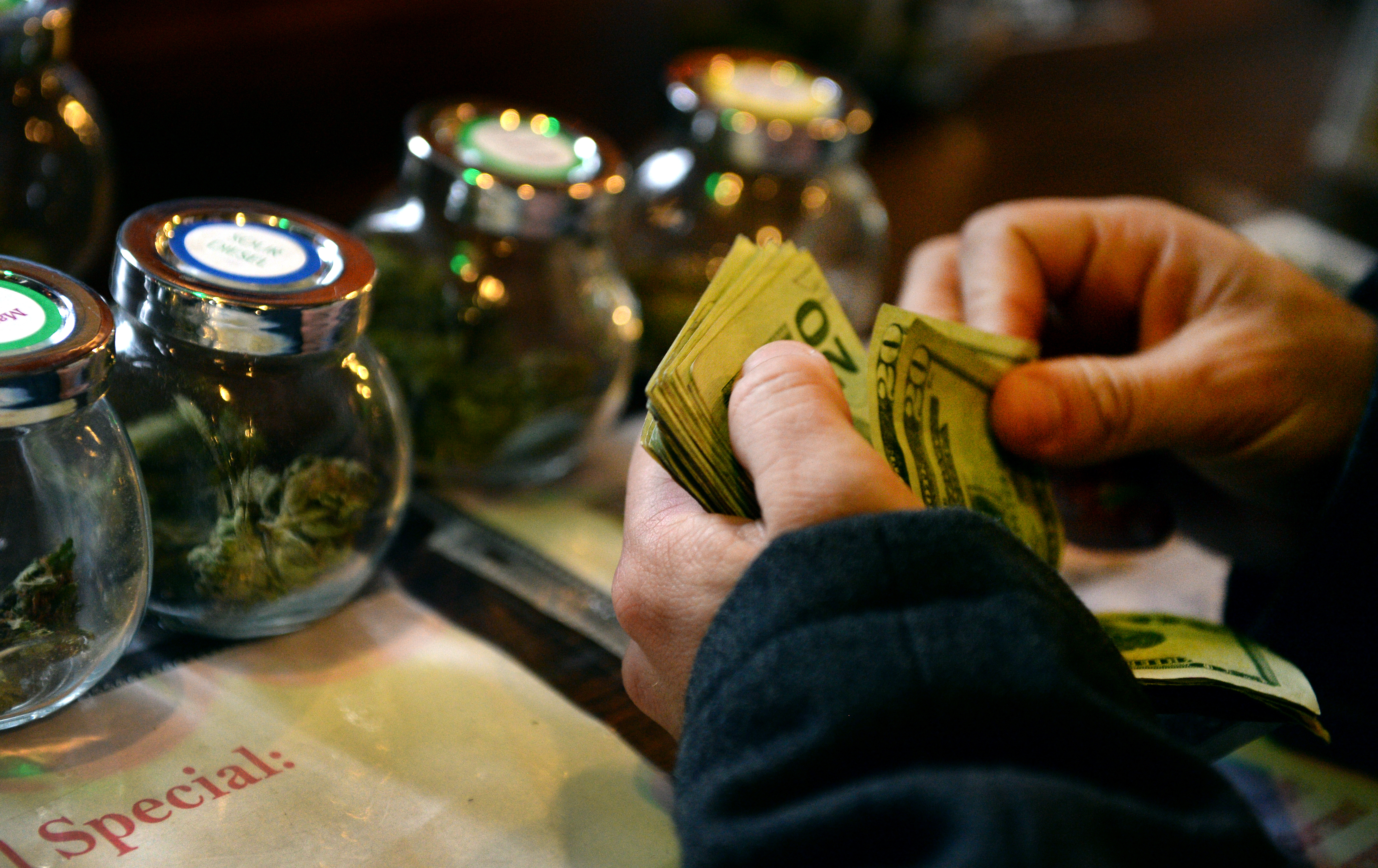 A tour member purchases marijuana at La Conte's Clone Bar &amp; Dispensary during a marijuana tour in Denver on Dec. 6, 2014 (Craig F. Walker—The Denver Post/MediaNews Group/Getty Images)