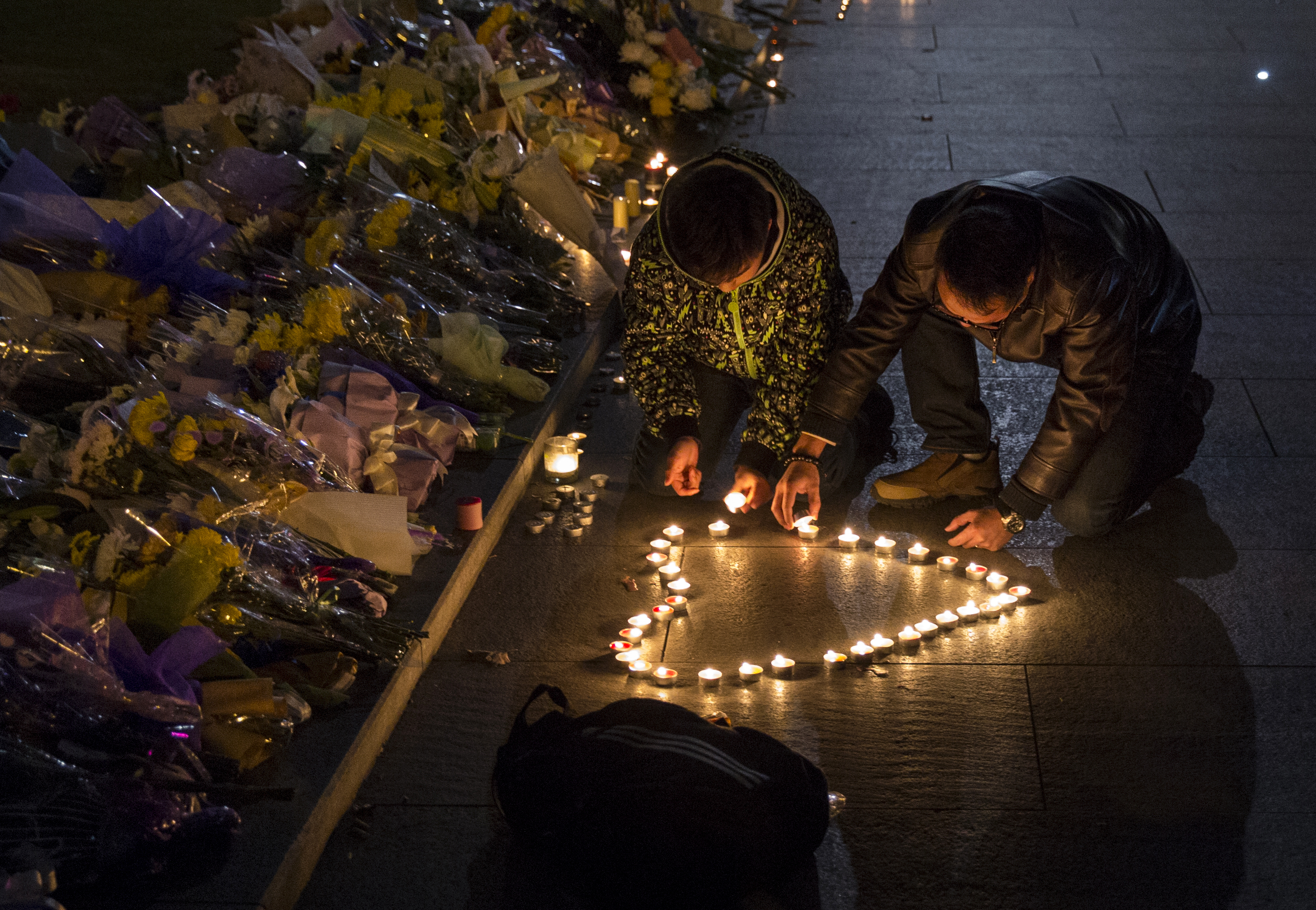 Mourners light candles in the shape of a heart at a makeshift memorial at the site of a stampede on January 1, 2015 on the Bund in Shanghai, China. More than 35 people died and dozens were injured during a stampede at a New Years eve celebration late December 31, 2014. (Kevin Frayer—Getty Images)