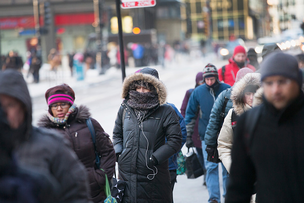 Commuters make their way to work as temperatures hovered around zero degrees Fahrenheit during the morning rush on January 5, 2015 in Chicago