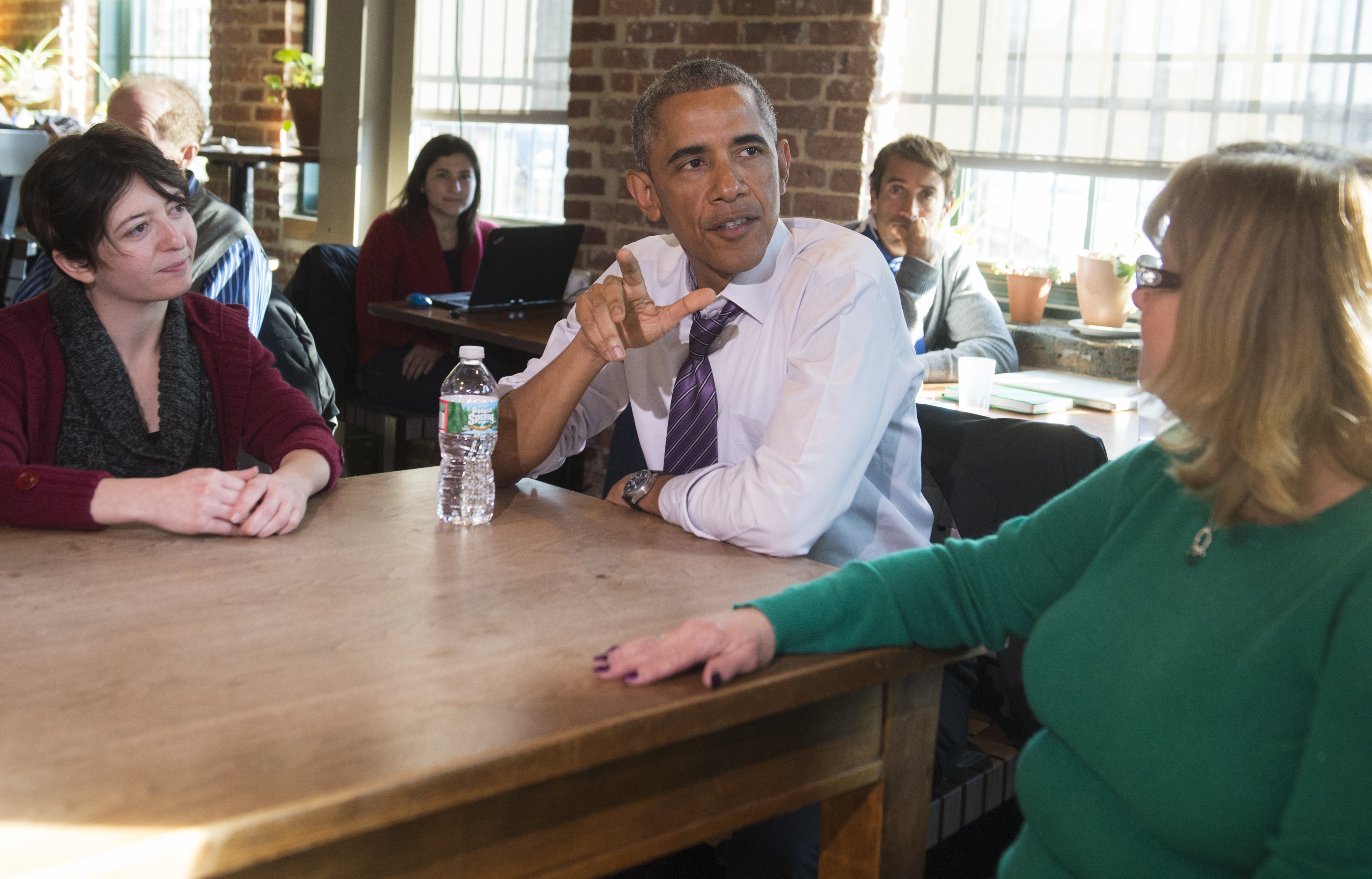 U.S. President Barack Obama speaks about increasing family leave for working Americans with Mary Stein, right, and Amanda Rothschild, left, after having lunch  in Baltimore (Saul Loeb—AFP/Getty Images)