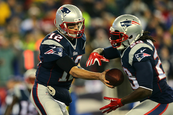 Tom Brady of the New England Patriots hands the ball off to LeGarrette Blount in the first quarter of the 2015 AFC Championship Game at Gillette Stadium in Foxboro, Mass., on Jan. 18, 2015 (Elsa&mdash;Getty Images)
