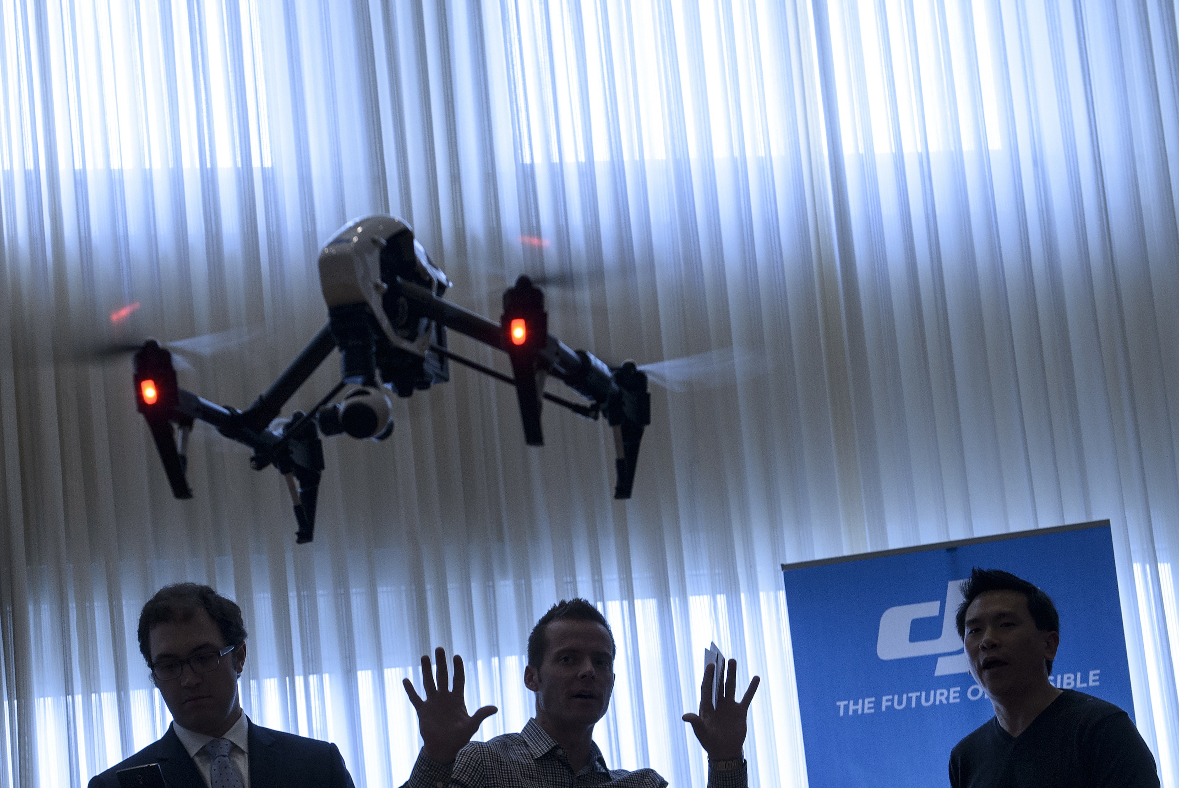 Staff from aerial imaging company DJI, demonstrate a remote control aircraft during a press conference by the Small UAV Coalition January 20, 2015 in Washington, DC. (Brendan Smialowski—AFP/Getty Images)