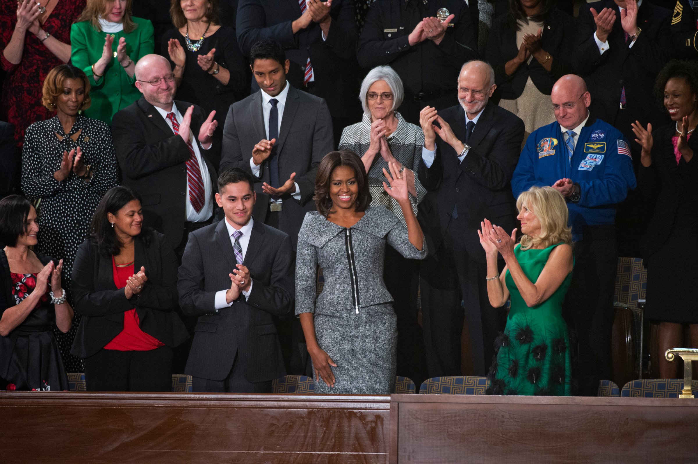UNITED STATES - JANUARY 20: First Lady Michelle Obama arrives in the Capitol's House chamber before President Barack Obama's State of the Union address, January 20, 2015. Jill Biden, wife of Vice President Joe Biden, appears at right. (Photo By Tom Williams/CQ Roll Call)