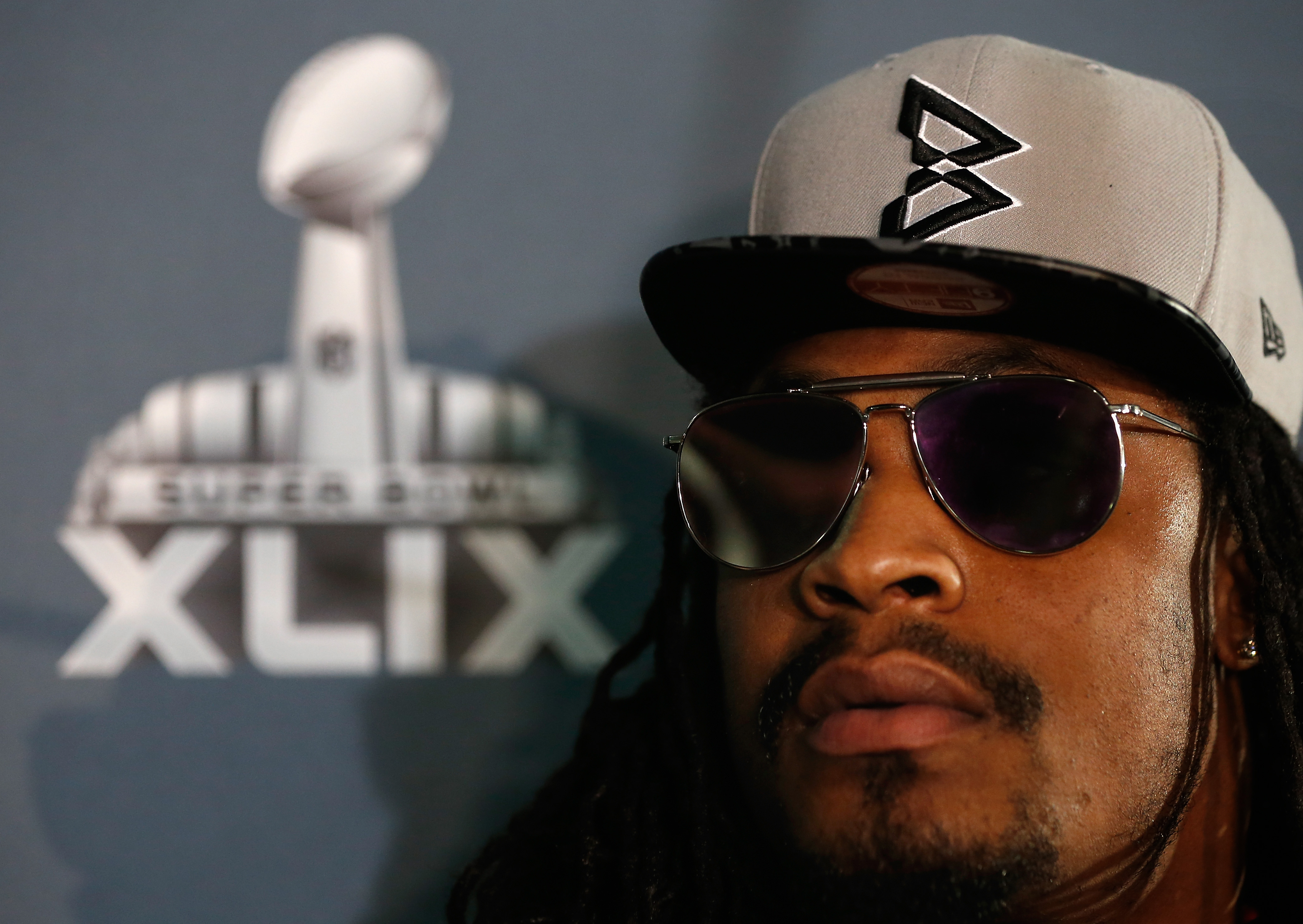 Seattle Seahawks running back Marshawn Lynch  sits at his podium during a Super Bowl XLIX media availability at the Arizona Grand Hotel on January 28, 2015 in Chandler, Arizona. (Christian Petersen&mdash;Getty Images)