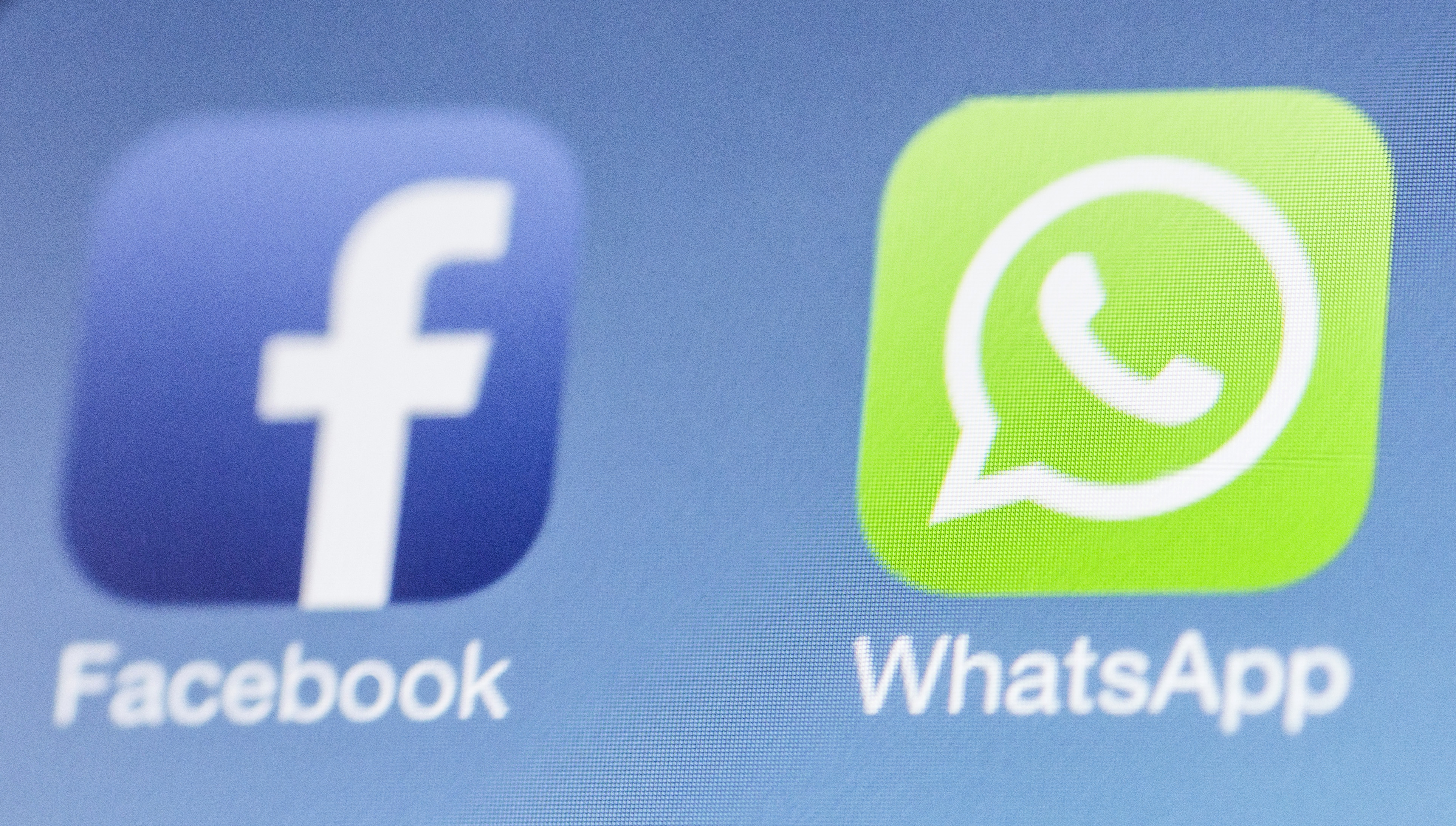 Facebook next to the WhatsApp logo on iPhone on February 25, 2014 in Berlin, Germany. (Marie Waldmann—Photothek/Getty Images)