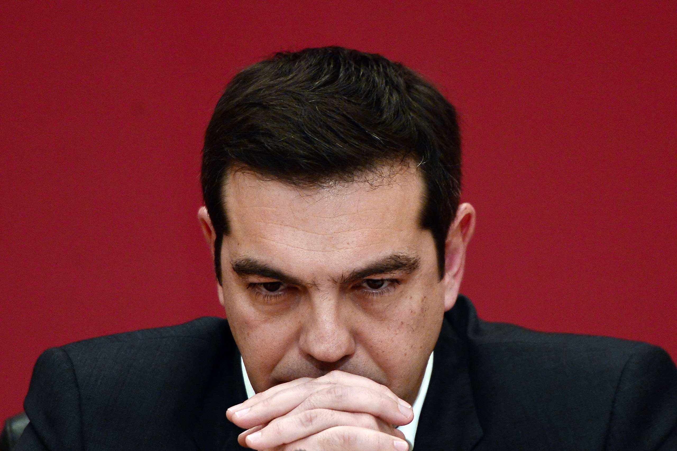 The leader of Syriza party, Alexis Tsipras, listens to a question during a televised press conference on Jan. 23, 2015 at the Zappion Hall in Athens. (Louisa Gouliamaki—AFP/Getty Images)