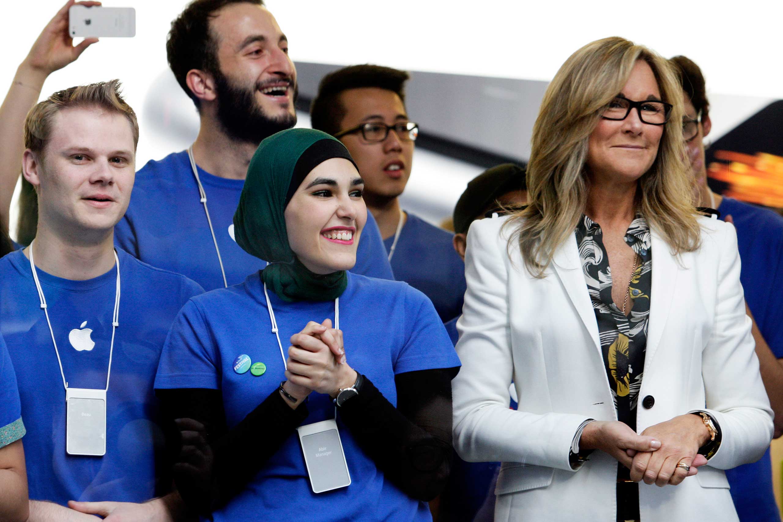 Angela Ahrendts, senior vice president of retail and online stores at Apple Inc., right, and employees look on before opening the doors to the company's George Street store for the sales launch of the iPhone 6 and iPhone 6 Plus in Sydney on Sept. 19, 2014. (Lisa Maree Williams—Bloomberg/Getty Images)