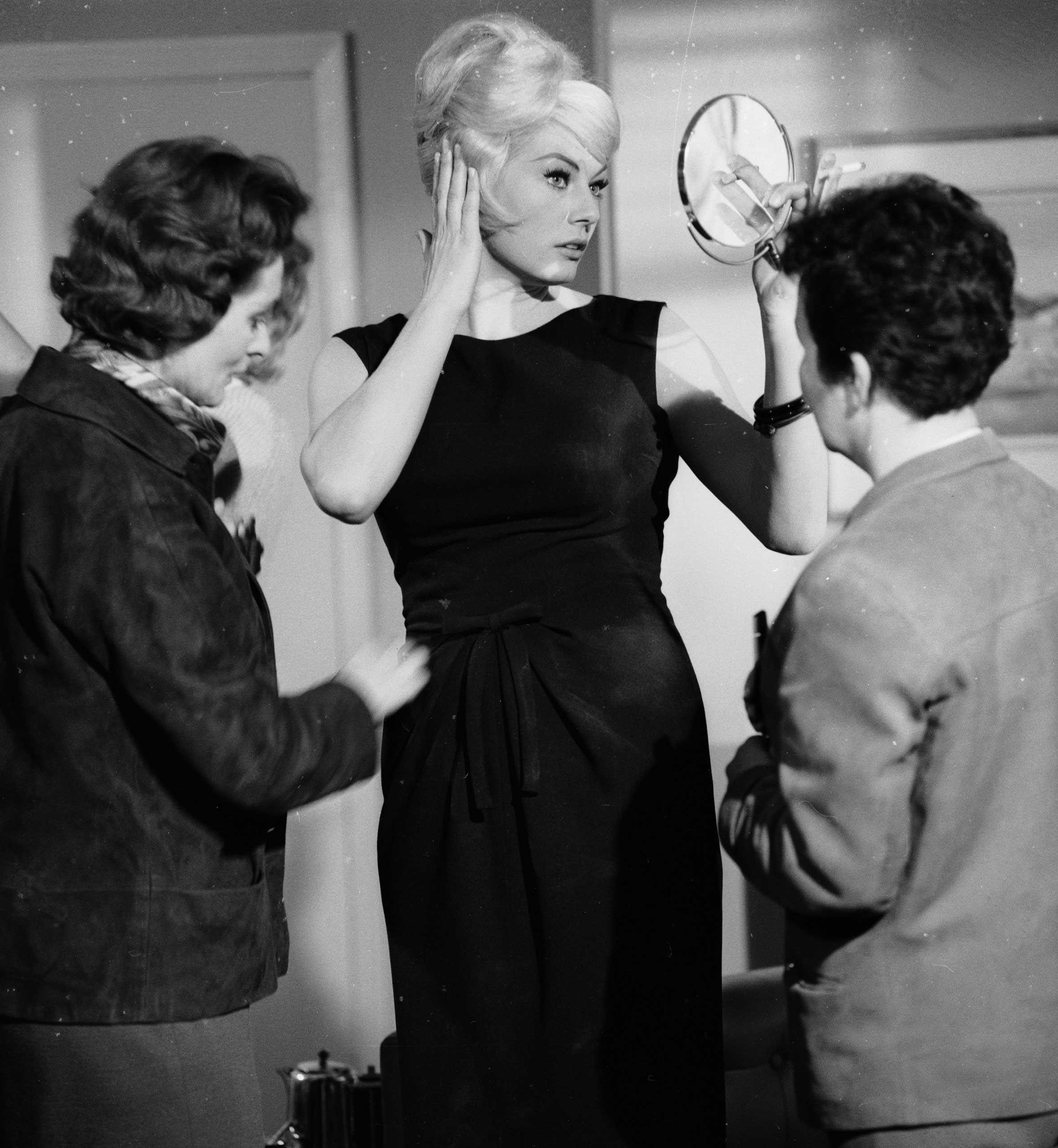 Ekberg checks her hair between takes of Call Me Bwana on Nov. 8, 1962.