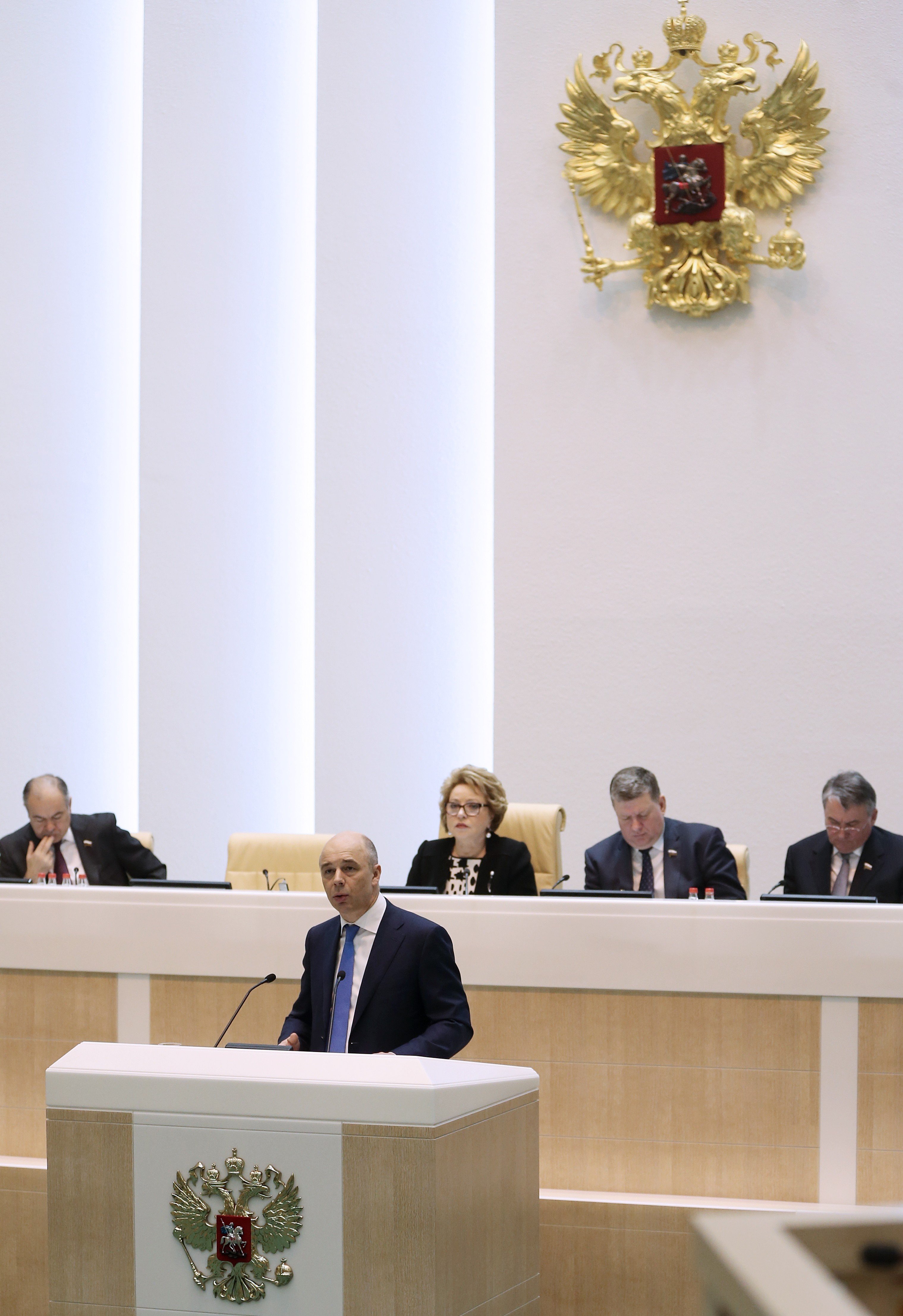 Russian Federation Council member Anton Siluanov delivers a speech as Russian Federation Council deputy chairman Ilyas Ukhmanov, Russian Federation Council chairperson Valentina Matviyenko, Russian Federation Council deputy chairmen Evgeny Bushmin and Yuri Vorobyov (L to R, background) look on at a plenary meeting of the Russian Federation Council on Jan. 28, 2015.
