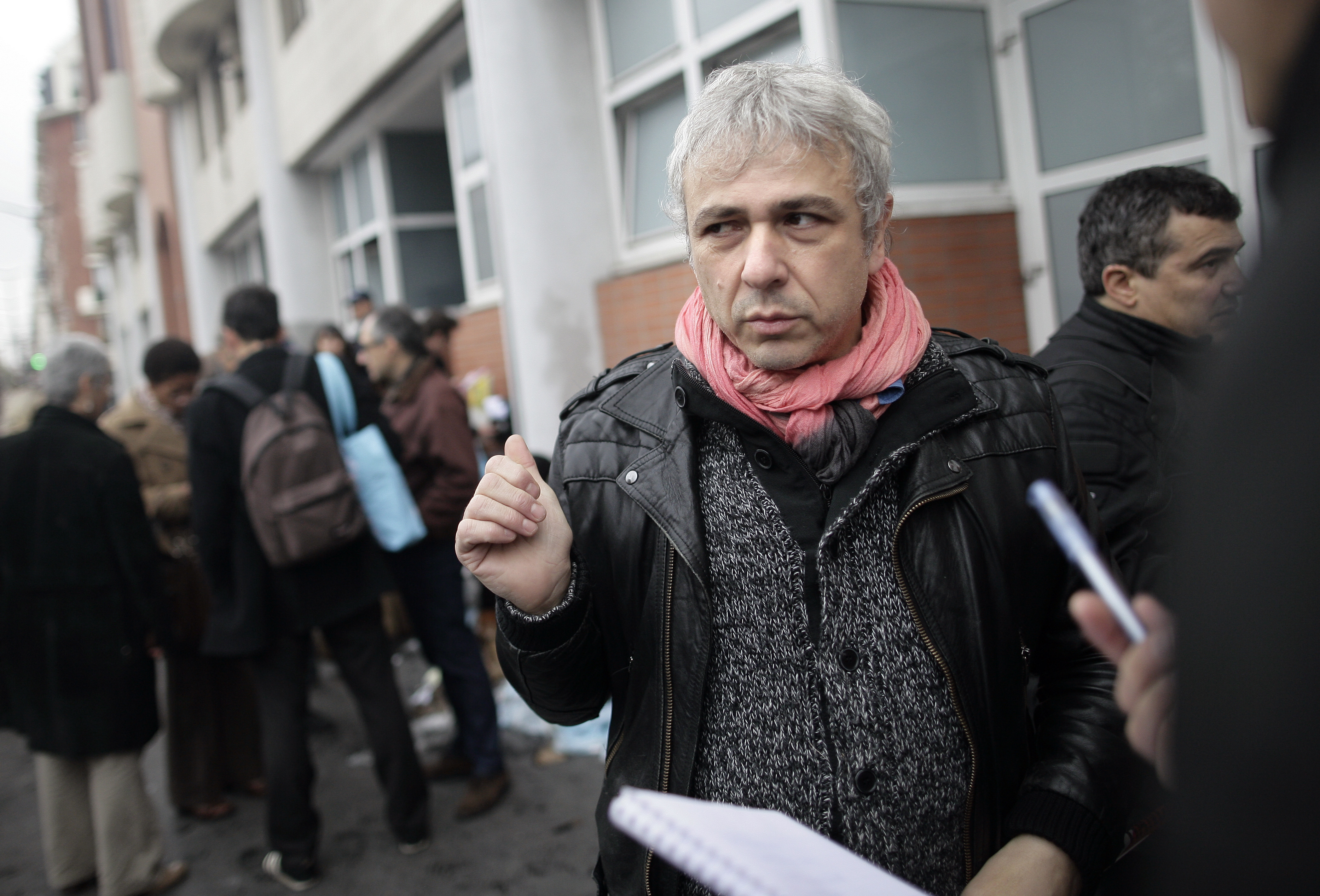 Cartoonist Antonio Fischetti speaks to journalists in front of the offices of French satirical newspaper <i>Charlie Hebdo</i> on Nov. 2, 2011, in Paris after they were destroyed by a petrol-bomb attack overnight (Alexander Klein—AFP/Getty Images)