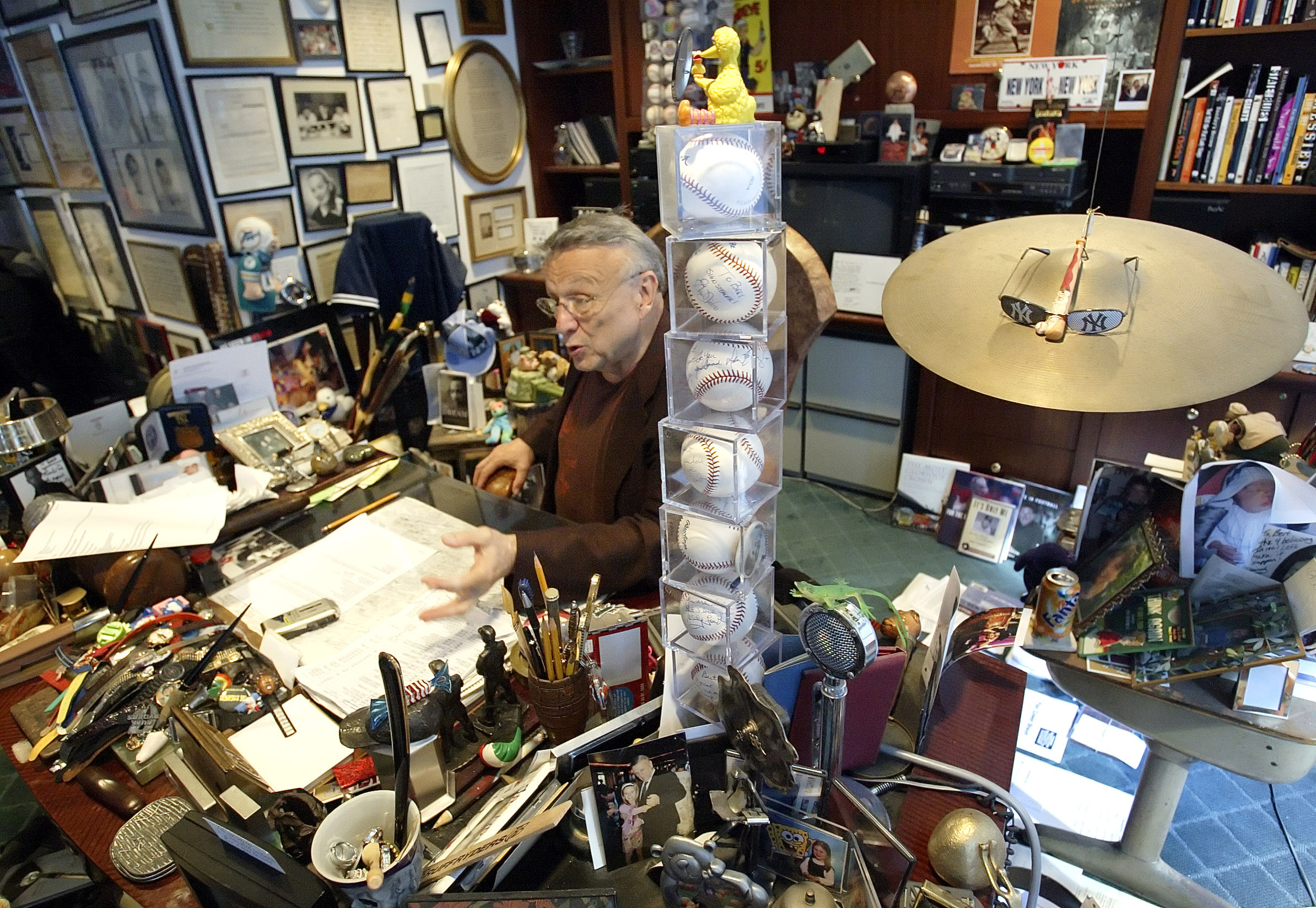 In this photo from Sept. 28, 2005, Bert Padell talks behind a tower of signed baseballs on his desk in his office in New York on Sept. 28, 2005.