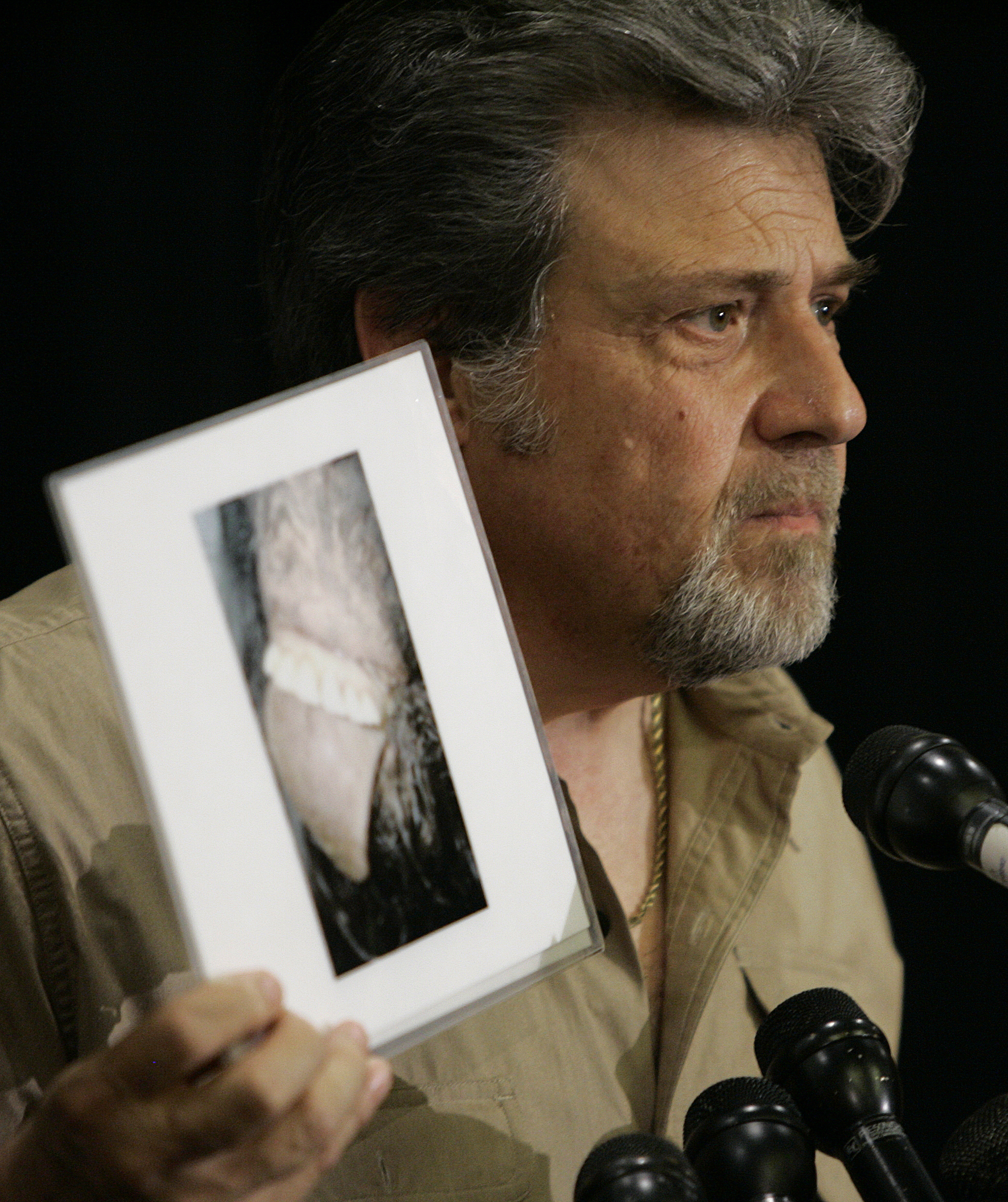 Bigfoot hunter Tom Biscardi holds a photo of what he claims to be the mouth and teeth of a deceased bigfoot or sasquatch creature during a news conference Friday, Aug. 15, 2008, in Palo Alto, Calif.