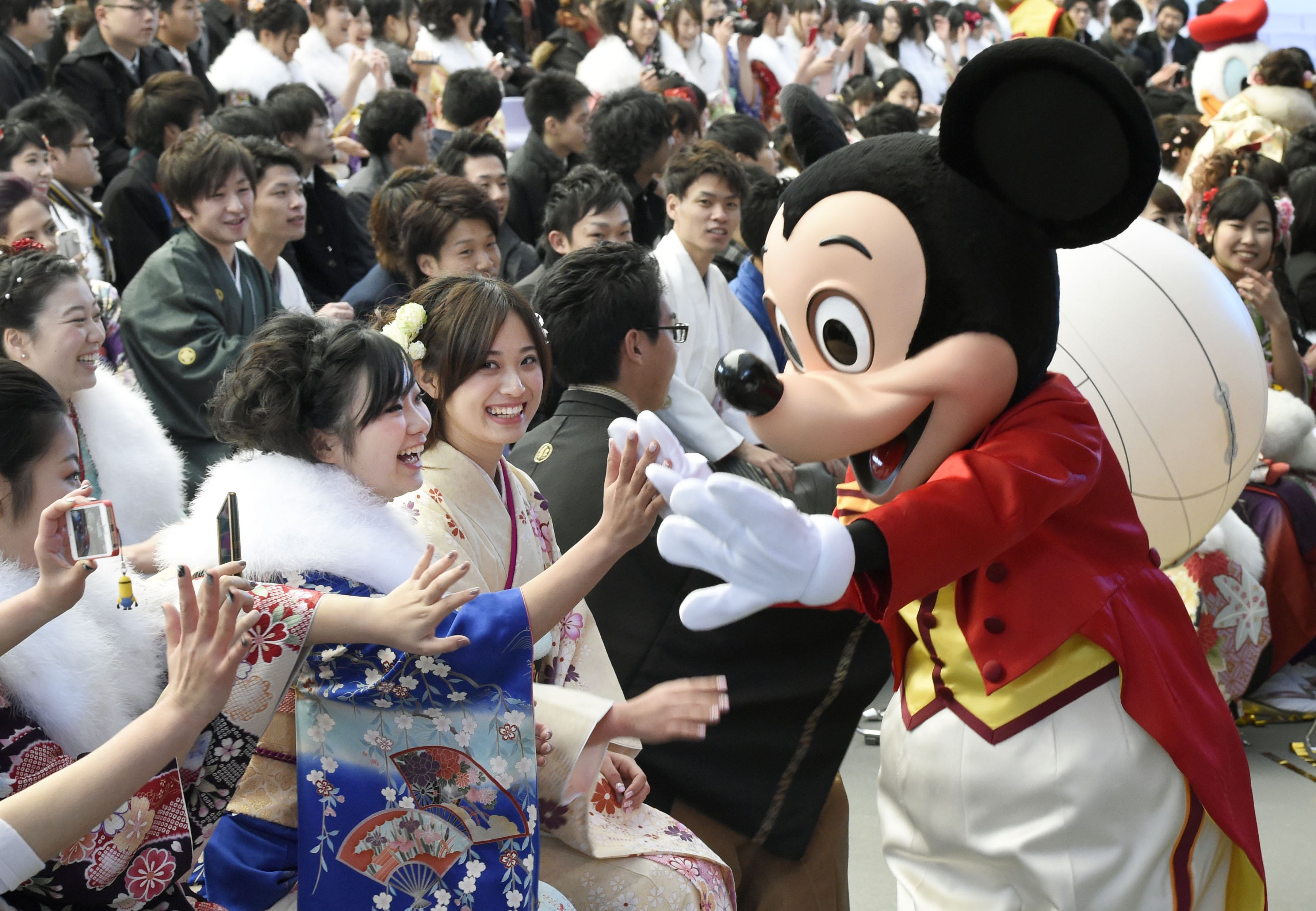 Mickey Mouse congratulates those who attended a coming-of-age ceremony at Tokyo Disneyland in Urayasu, near Tokyo, Japan, on Jan. 12, 2015 (Kyodo/AP)