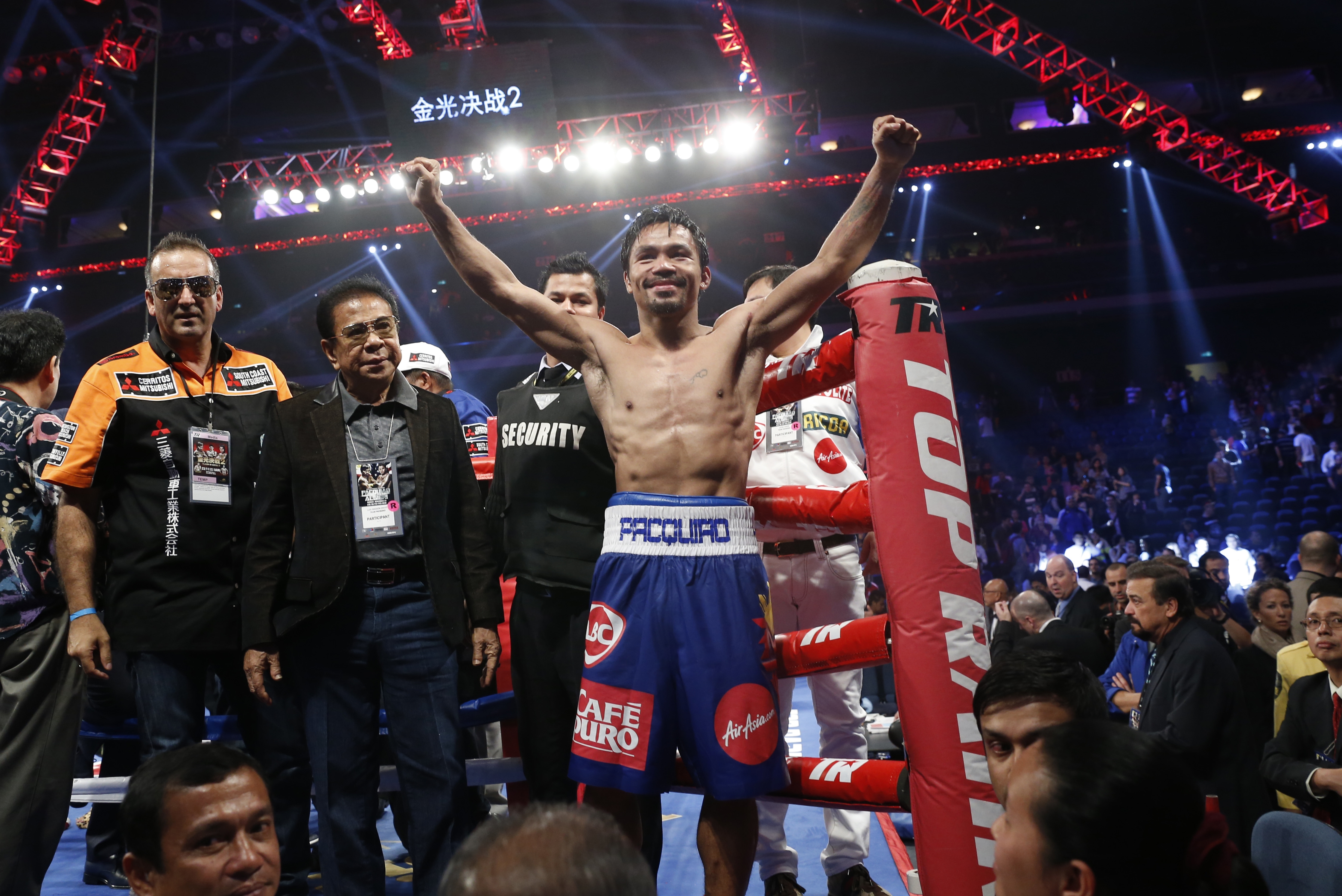WBO welterweight champion Manny Pacquiao, center, celebrates after defeating WBO junior welterweight champion Chris Algieri of the United States during their welterweight title boxing match at the Venetian Macao in Macau, Sunday, Nov. 23, 2014 (Kin Cheung—AP)