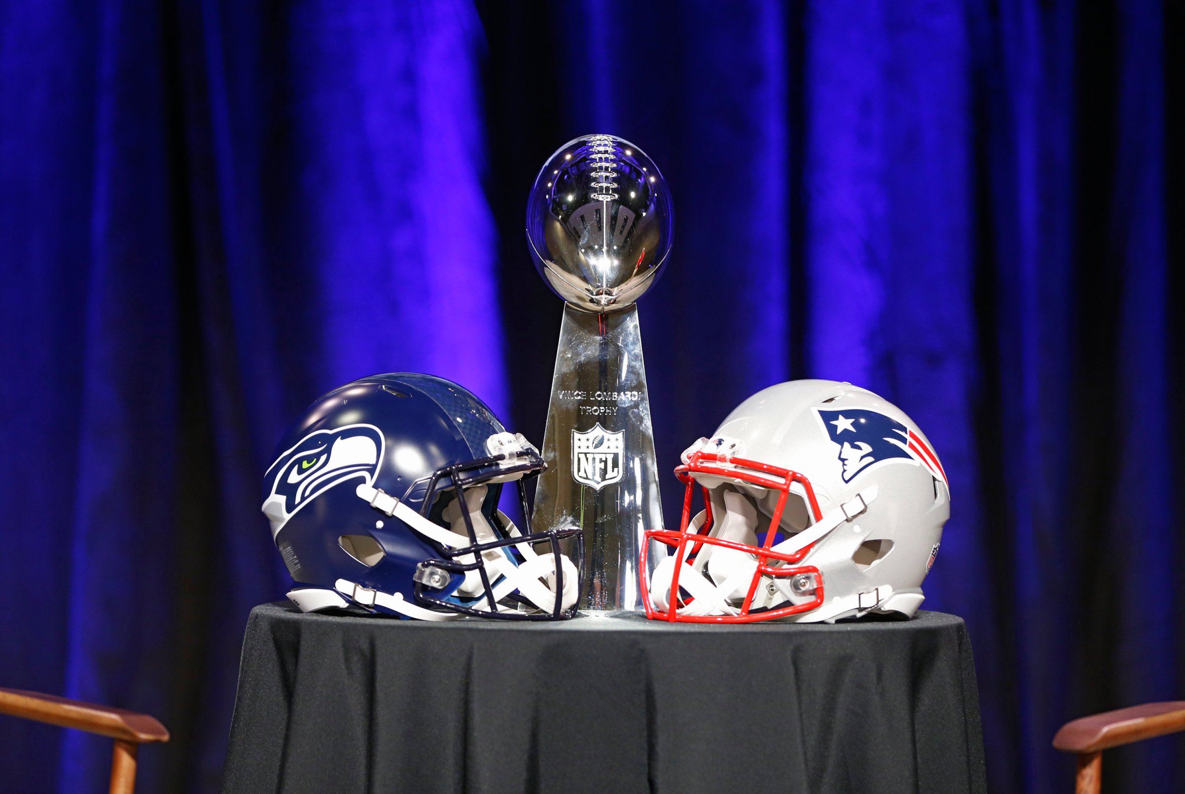 General view of the Super Bowl XLIX trophy with a helmet from both the Seattle Seahawks and the New England Patriots during a press conference for Super Bowl XLIX on Friday, Jan. 30, 2015, in Phoenix, Ariz.